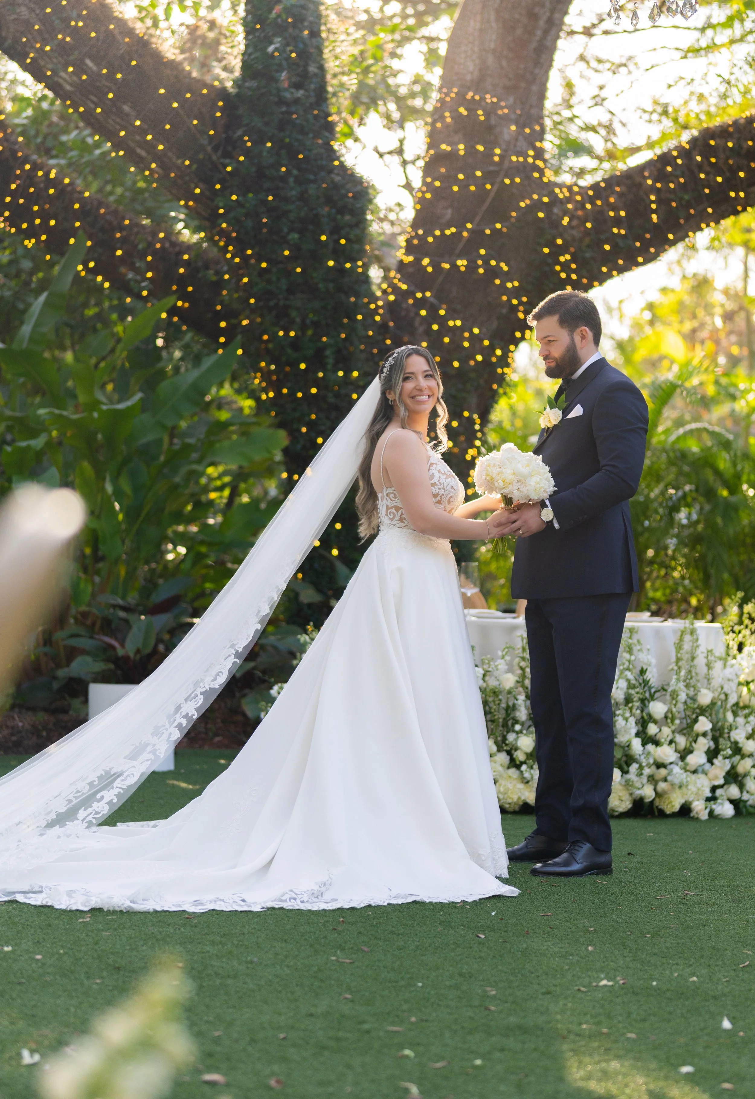 Full-length wedding couple portrait under the majestic Banyan tree at Villa Woodbine; fine art photography by Star Visual Art, Miami.