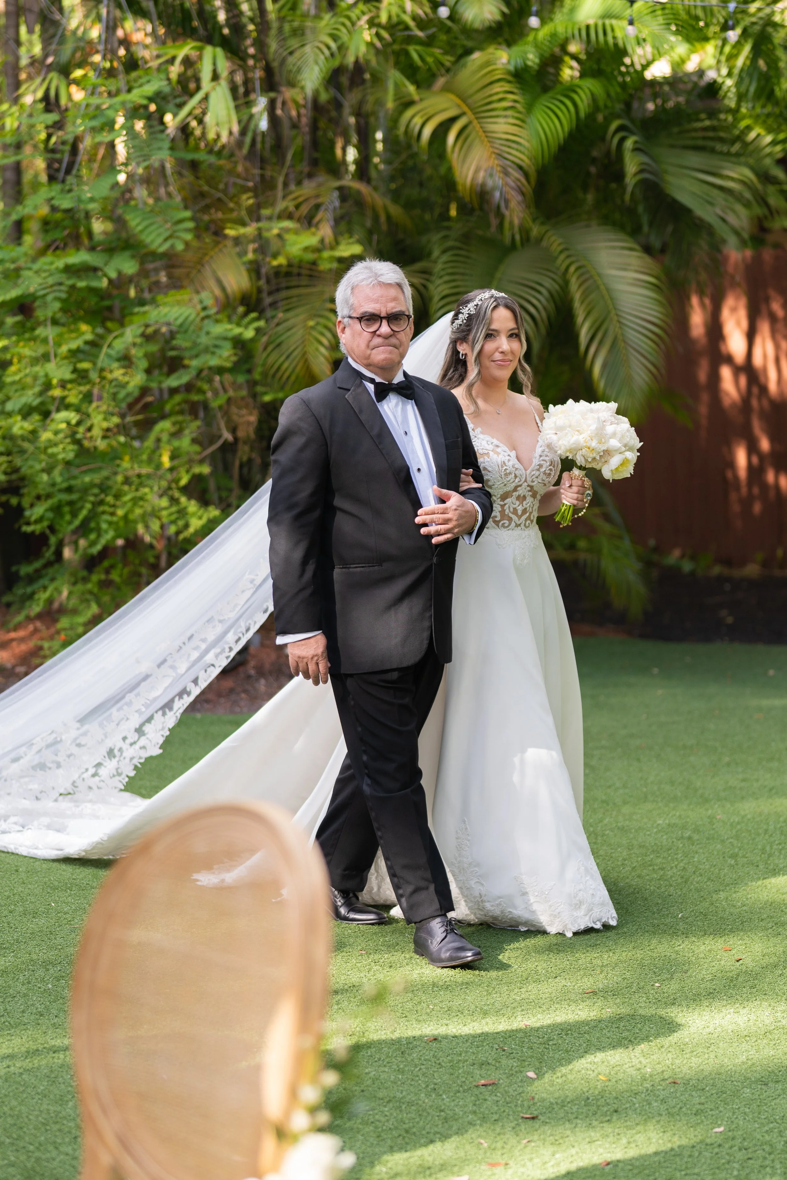 Romantic wedding couple walking through the lush gardens of Villa Woodbine; fine art photography by Star Visual Art, Miami.