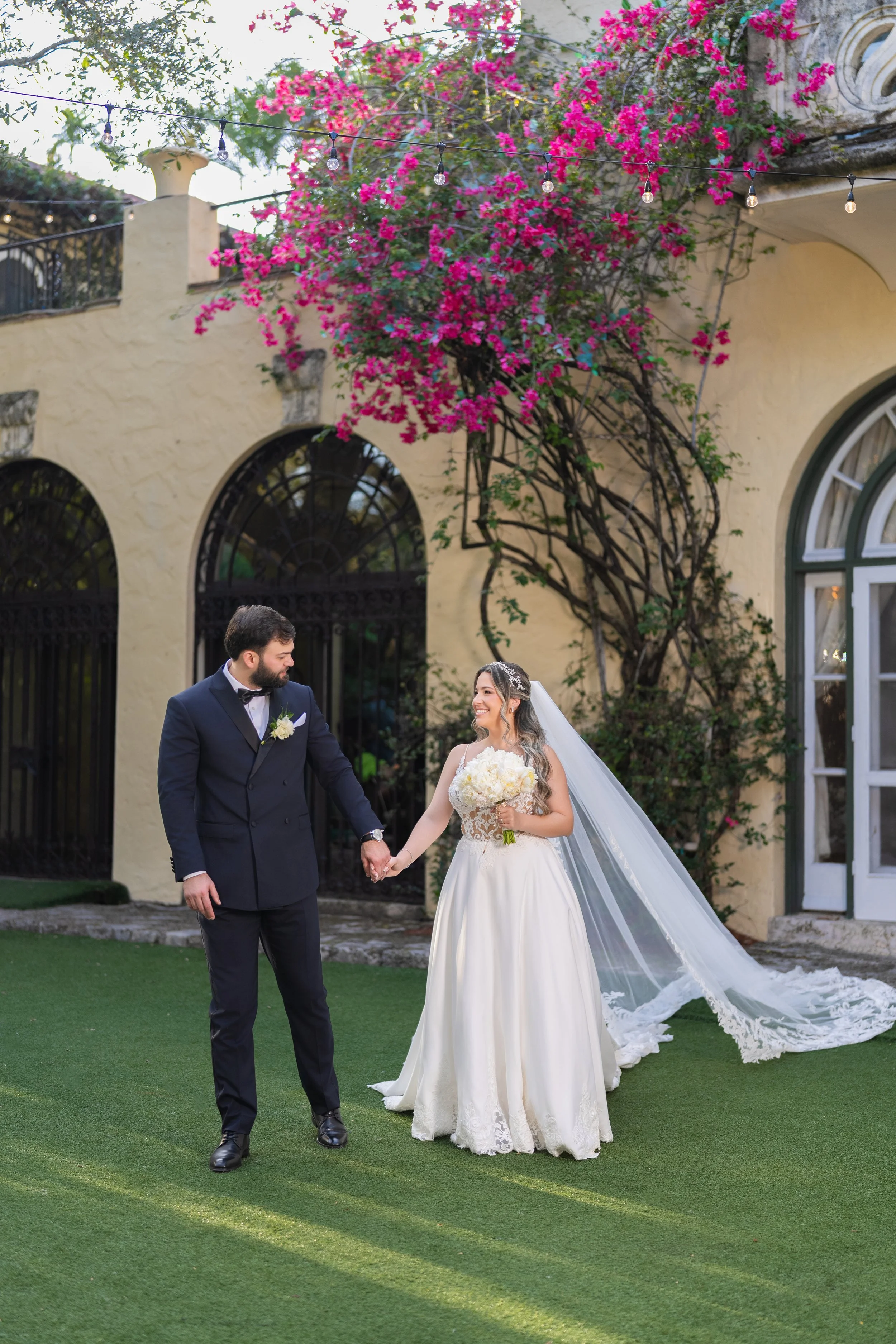 Elegant wedding couple portrait in front of the historic architecture at Villa Woodbine; fine art photography by Star Visual Art, Miami.