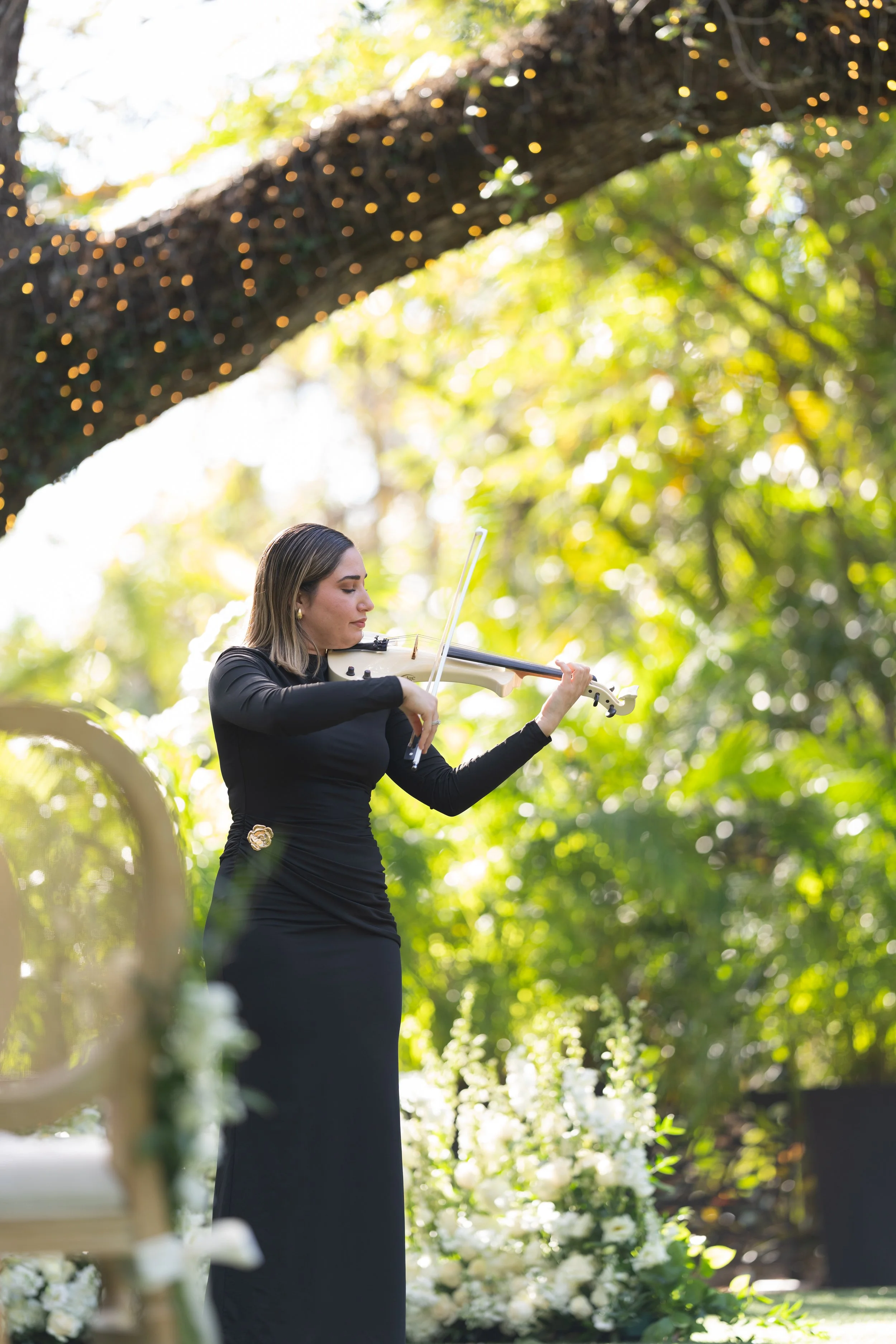 Live violinist performance during a garden wedding ceremony at Villa Woodbine; luxury event photography by Star Visual Art, Miami.