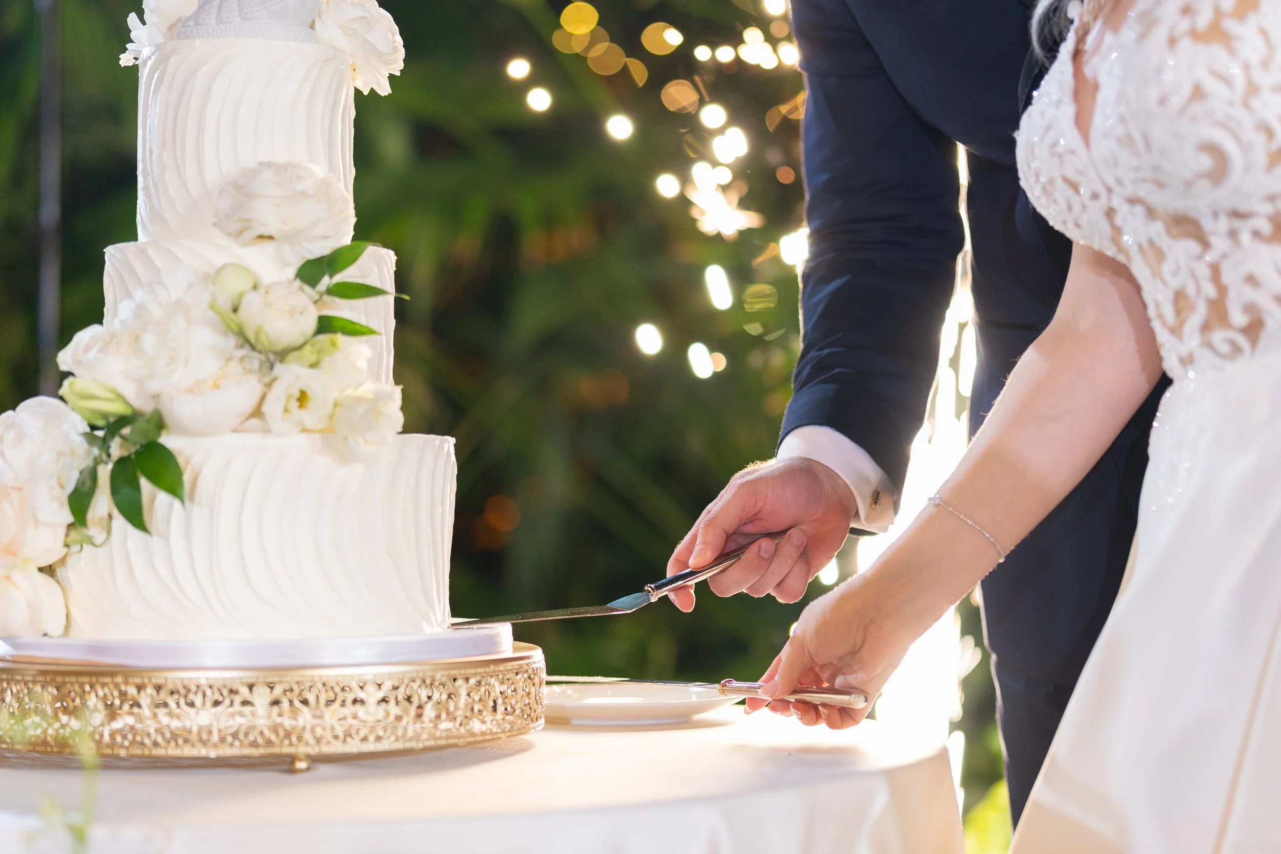Elegant white wedding cake with floral details at Villa Woodbine; fine art photography by Star Visual Art, Miami.