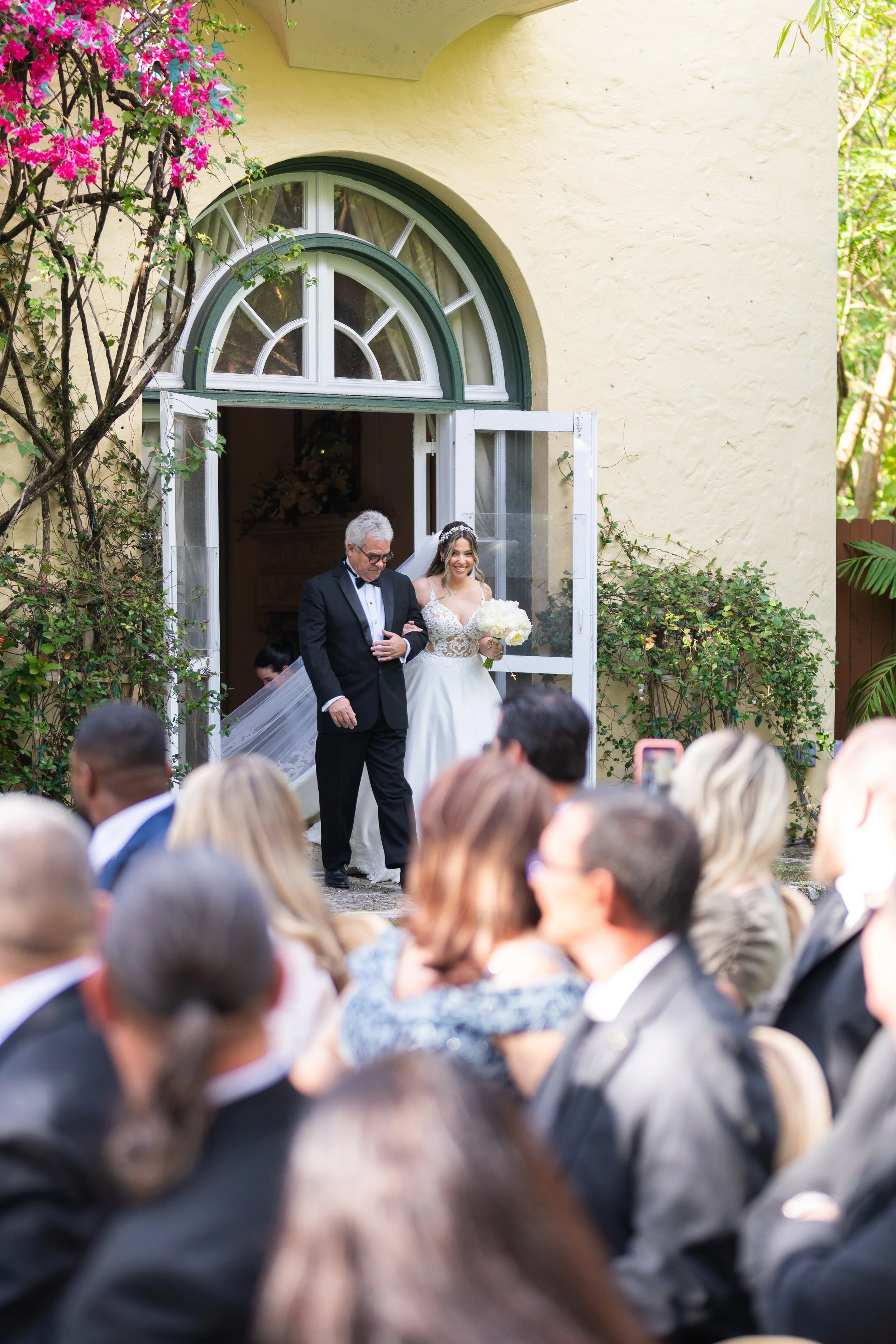 Joyful wedding couple ceremony exit with rose petals at Villa Woodbine; fine art photography by Star Visual Art, Miami.