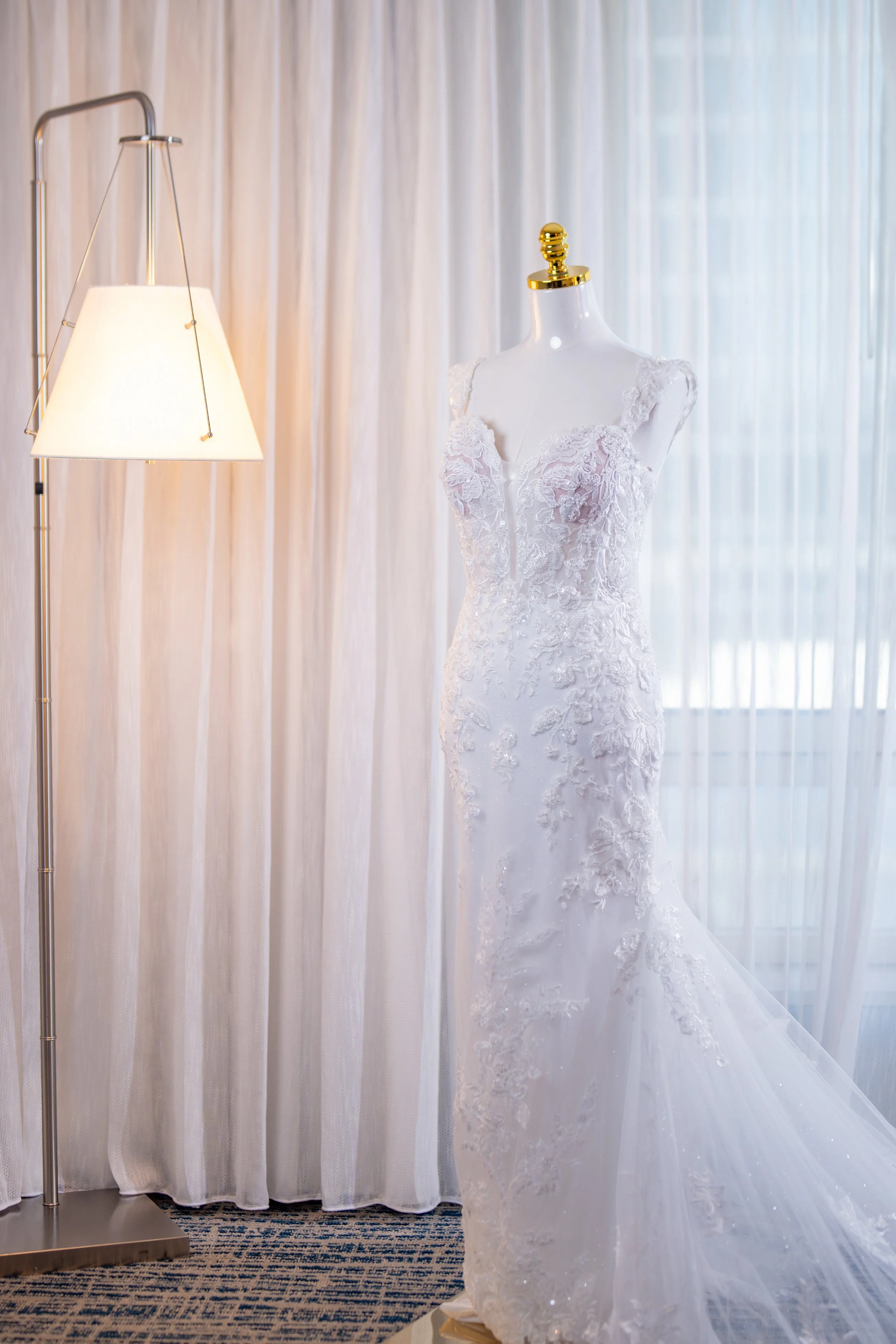 Elegant bridal gown on display at HILTON TAMPA DOWNTOWN; fine art wedding dress photography by Star Visual Art, Tampa.