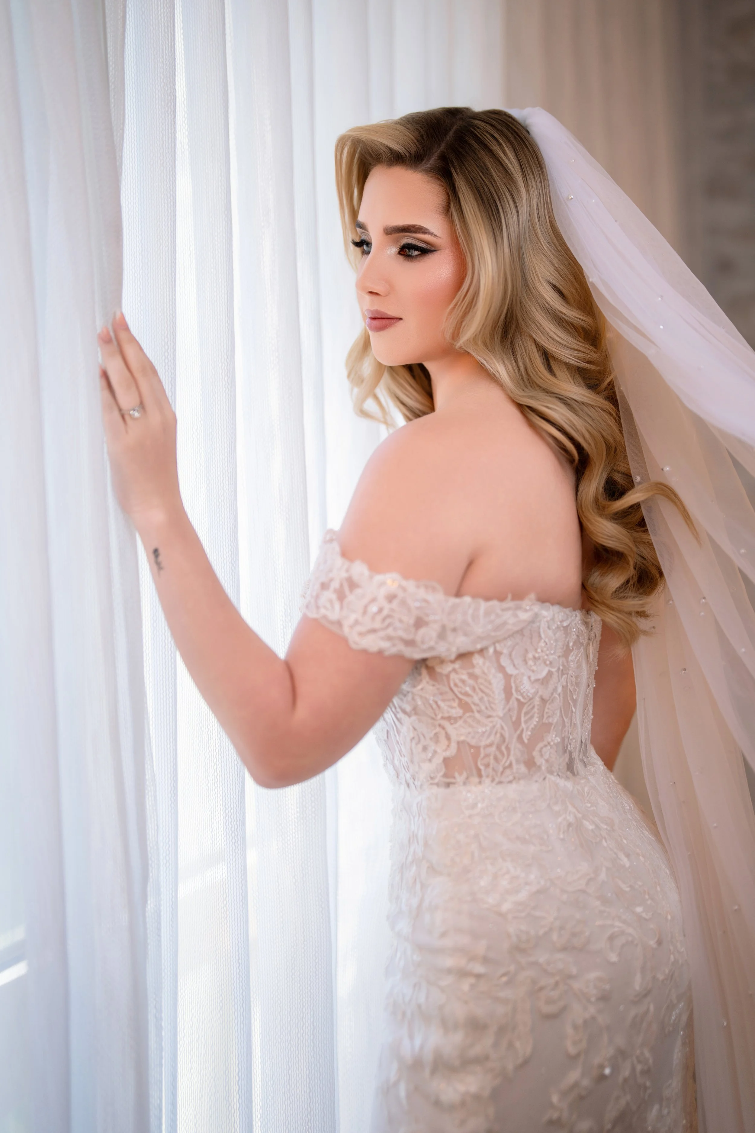 Stunning bridal portrait featuring a long veil and wedding dress at HILTON TAMPA DOWNTOWN; fine art photography by Star Visual Art, Tampa.