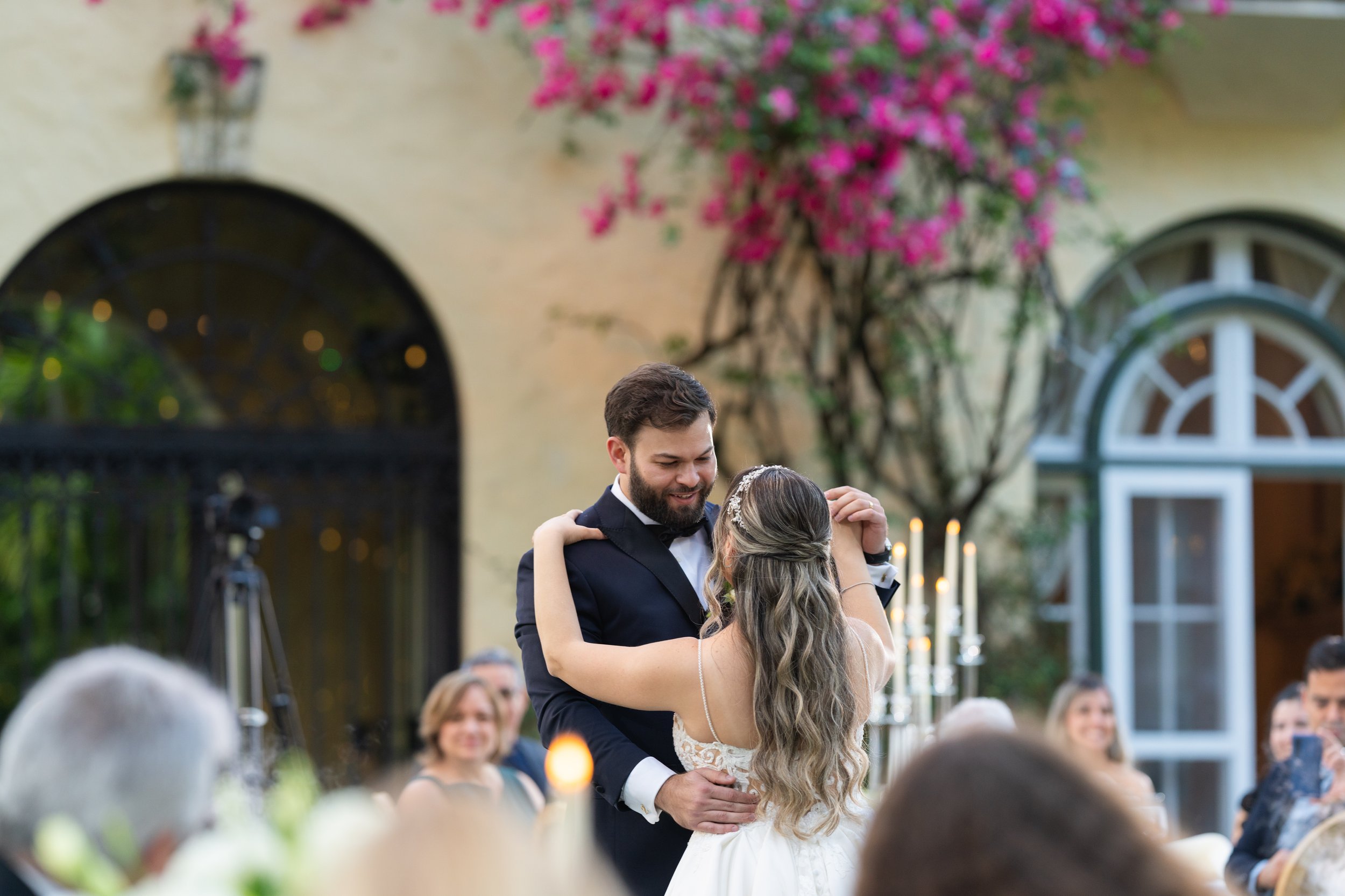 Joyful wedding couple's first dance at Villa Woodbine in Coconut Grove; luxury fine art photography by Star Visual Art, Miami.