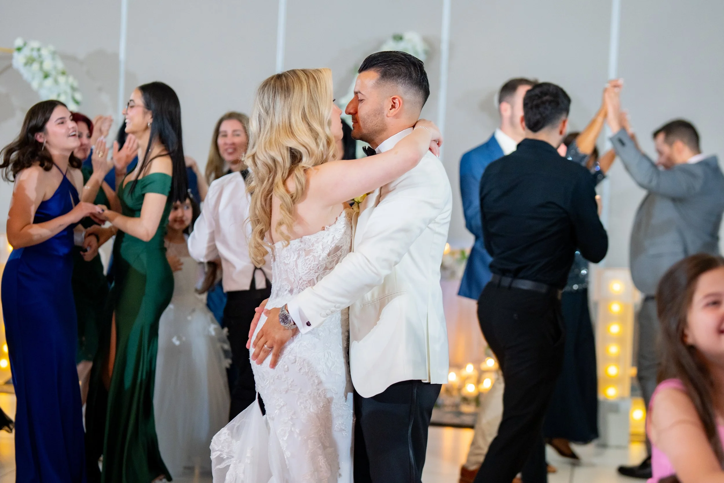 Cinematic first dance dip with wedding guests celebrating at HILTON TAMPA DOWNTOWN; professional reception party photography by Star Visual Art, Tampa.