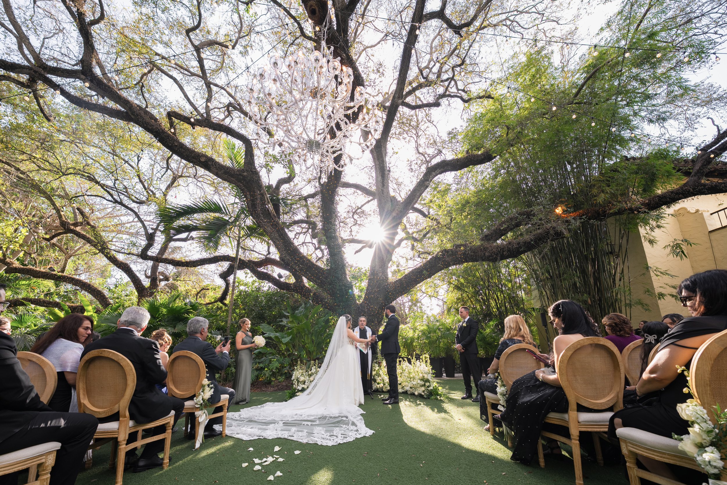 Luxury wedding altar design under the historic Banyan tree at Villa Woodbine; fine art photography by Star Visual Art, Miami.