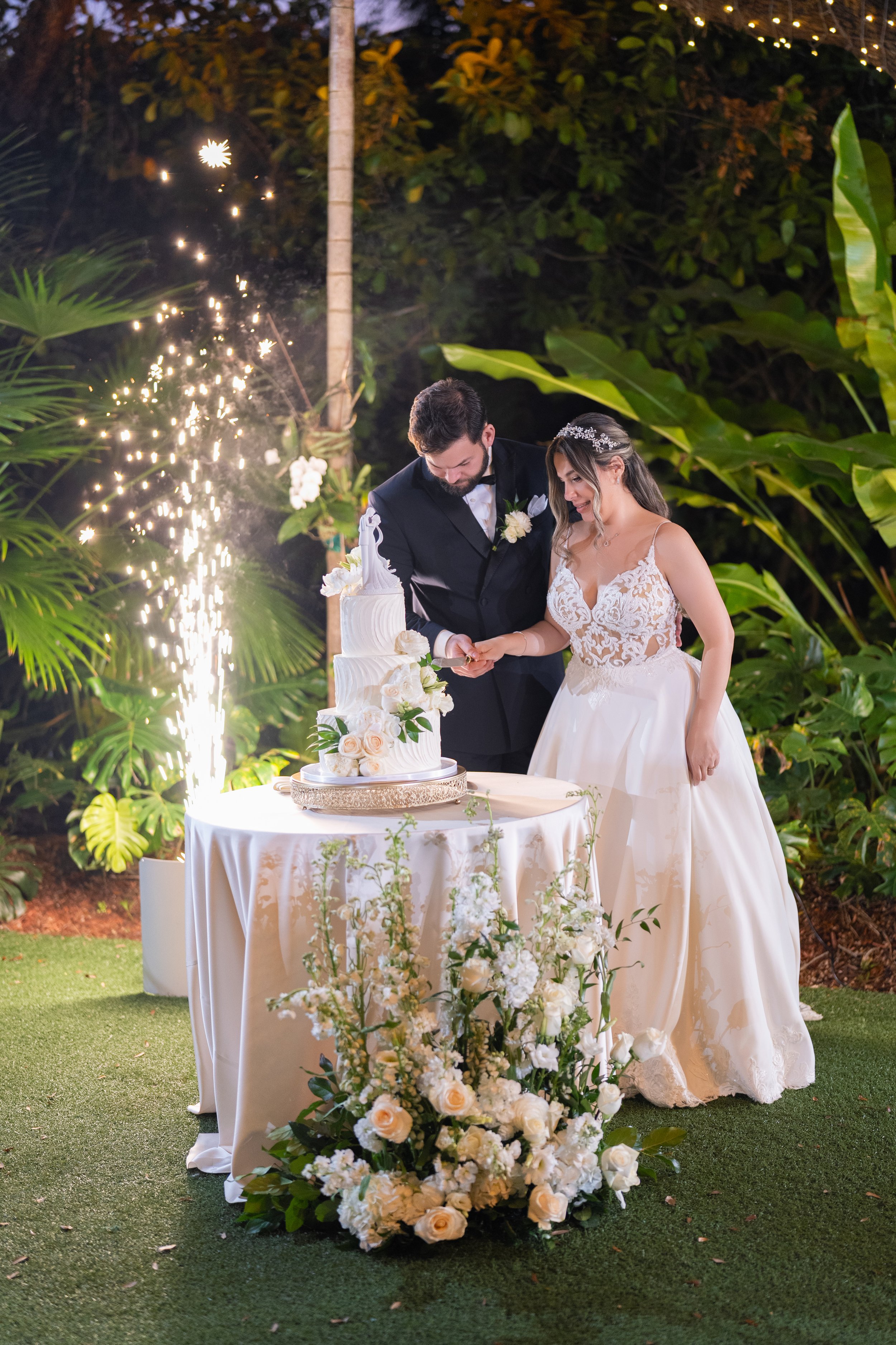 Elegant white wedding cake with floral details at Villa Woodbine; fine art photography by Star Visual Art, Miami.