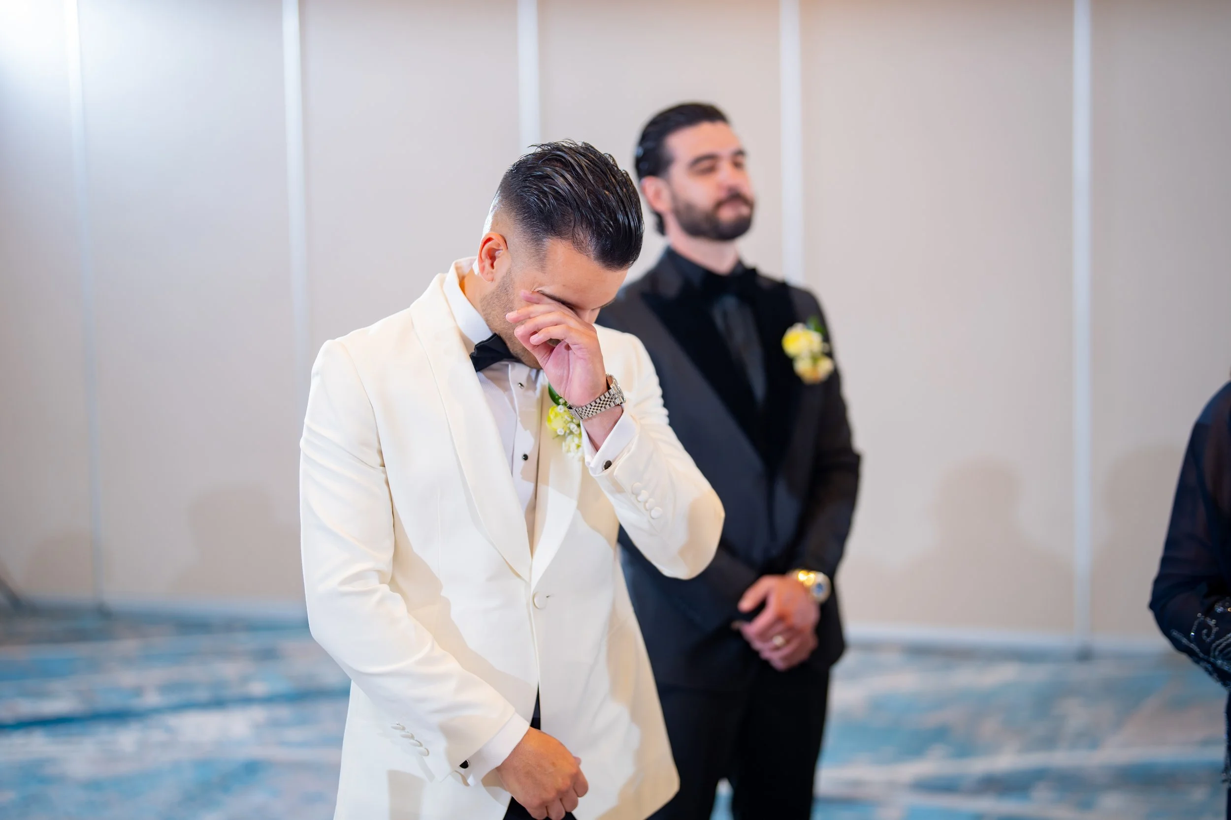 Emotional groom crying with tears of joy during the ceremony at HILTON TAMPA DOWNTOWN; professional wedding photography by Star Visual Art, Tampa.
