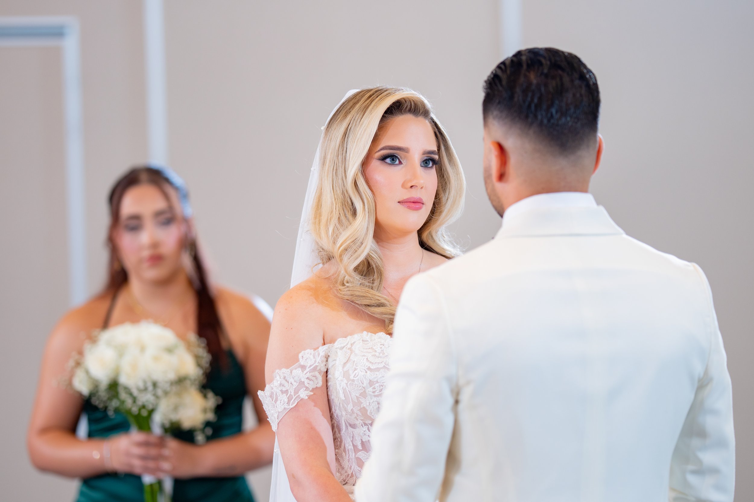 Bride and groom during their romantic ceremony at HILTON TAMPA DOWNTOWN; professional wedding photography by Star Visual Art, Tampa.