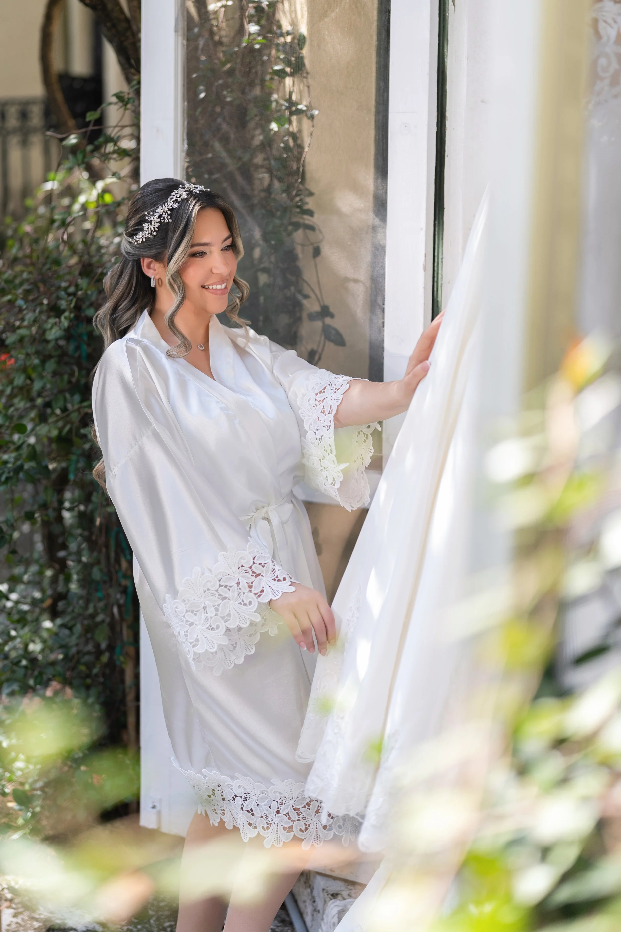 Elegant bride getting ready in a silk robe; fine art bridal photography by Star Visual Art, Miami.