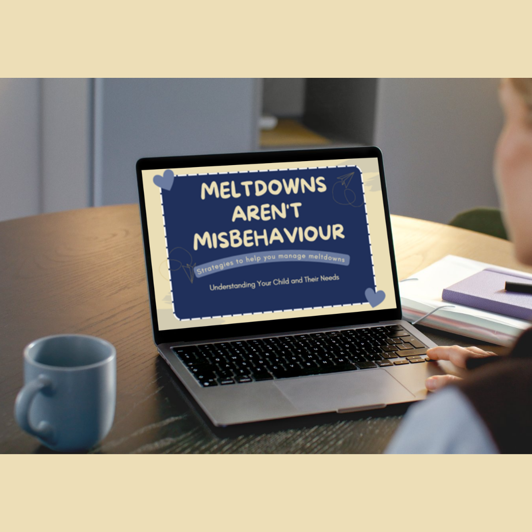 Laptop displaying a presentation by James' Guiding Star, titled 'Meltdowns Aren't Misbehaviour,' on a wooden table next to a white mug and some notebooks.