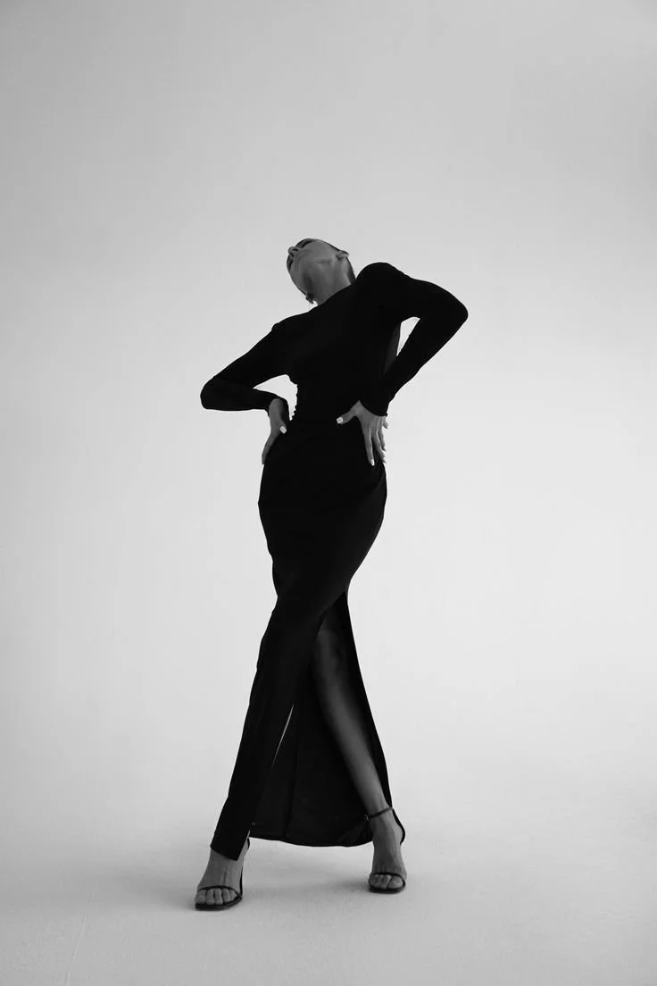 Woman in a dress and heels in an editorial pose, symbolising confidence, visibility, and a strong personal brand.