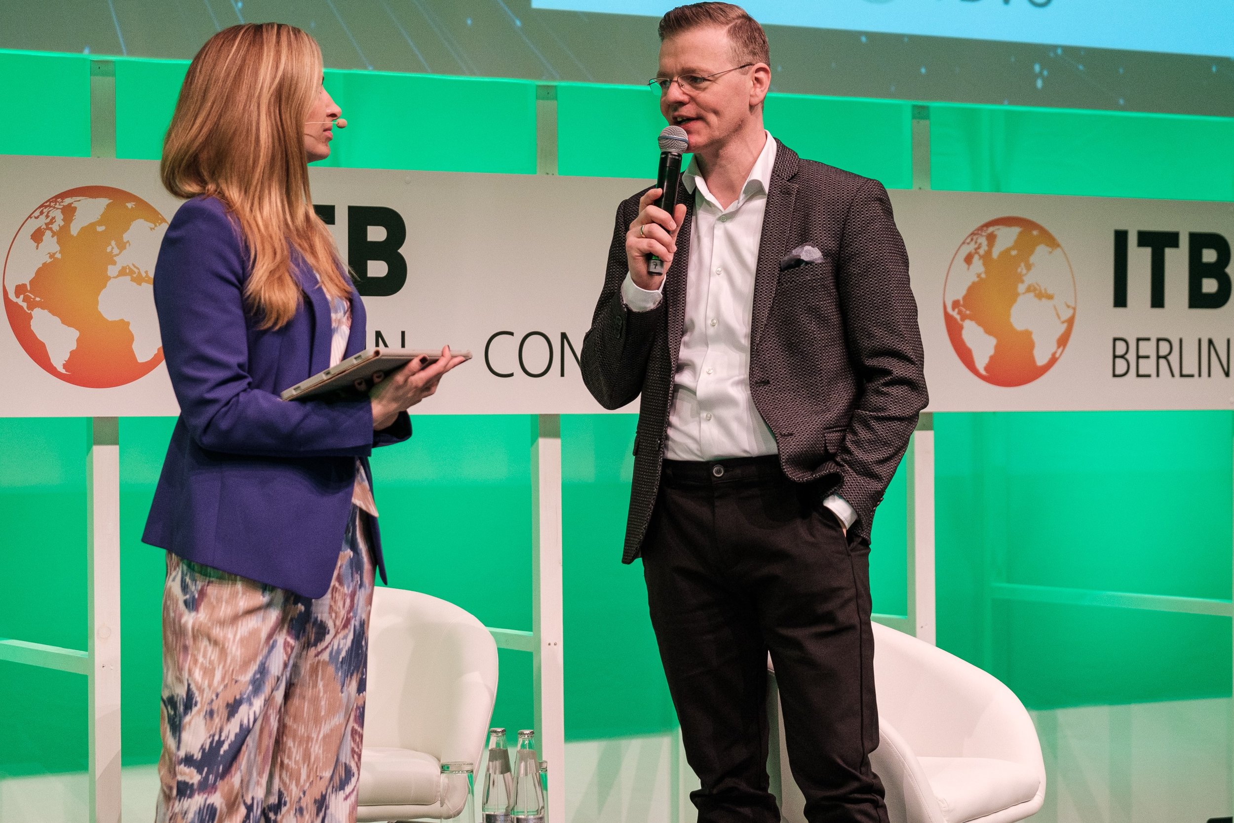 Bernd Fritzges, founder of MICE Desk, is speaking on stage at the ITB.