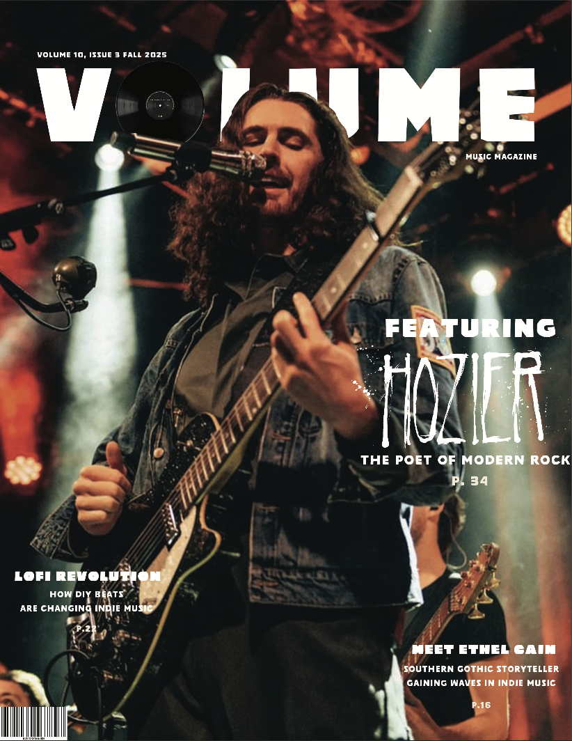 Magazine cover for 'Volume 10, Issue 3 Fall 2025' of VOLUME MAGAZINE features indie musician Hozier playing an electric guitar and singing into a microphone, performing on stage with colorful lighting. Created by graphic design student Kenzie Coates