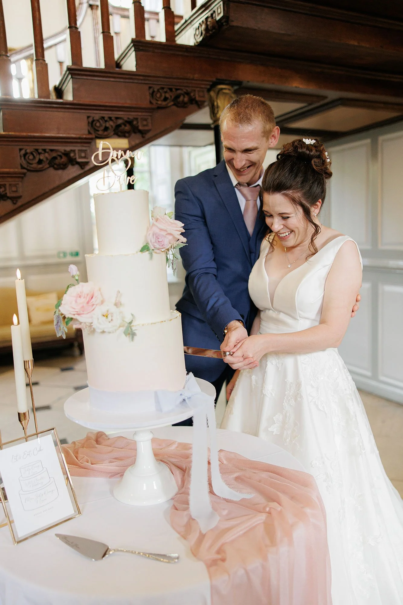 Couple cutting wedding cake