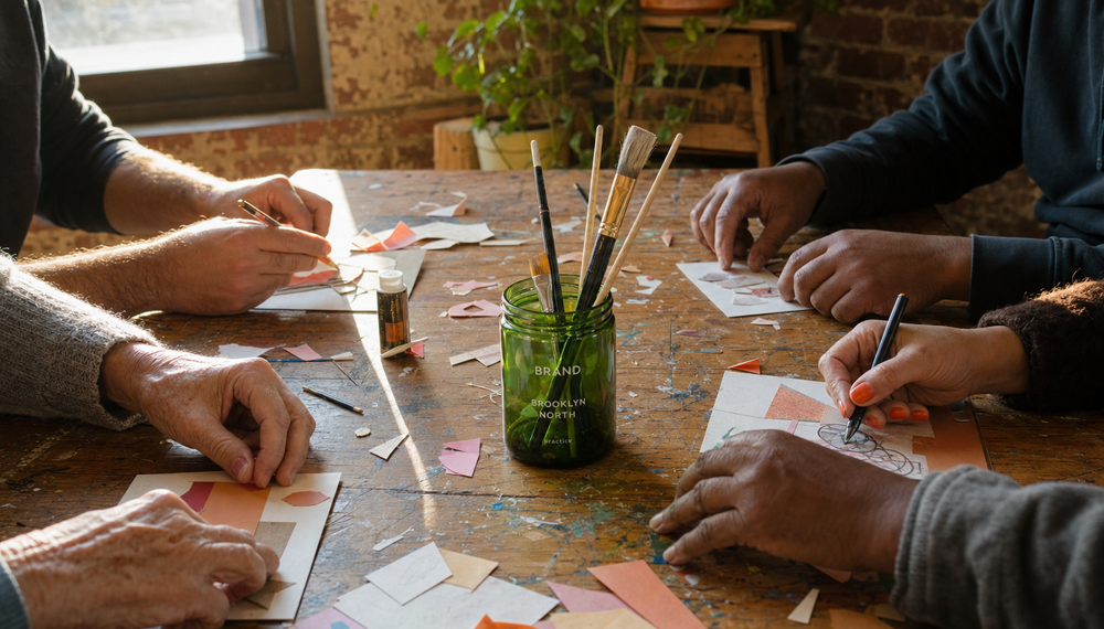Hands and art therapy materials at a shared table in the Brooklyn North room in Greenpoint, Brooklyn