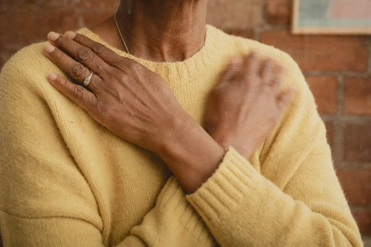 a middle aged woman in an emidr session with her hands crossed on her chest