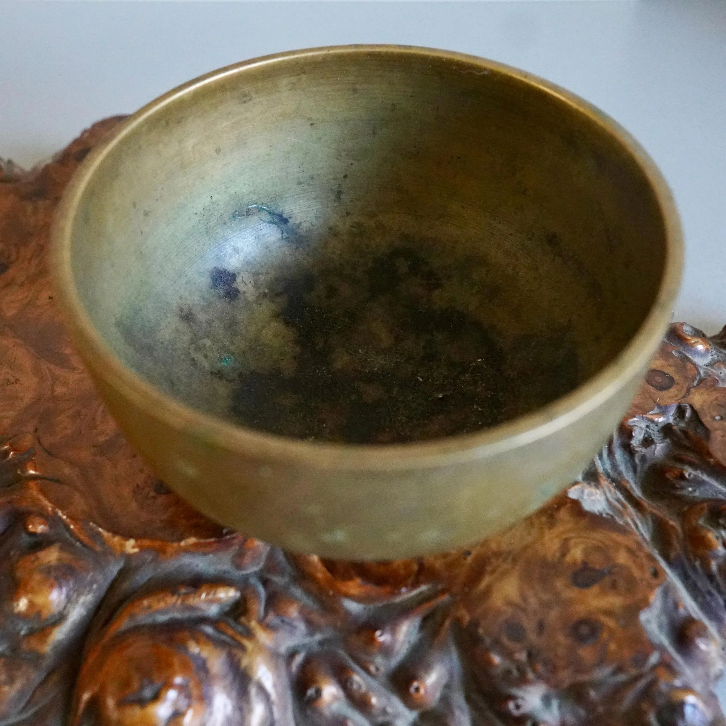 Interior detail of bronze orin bowl patina