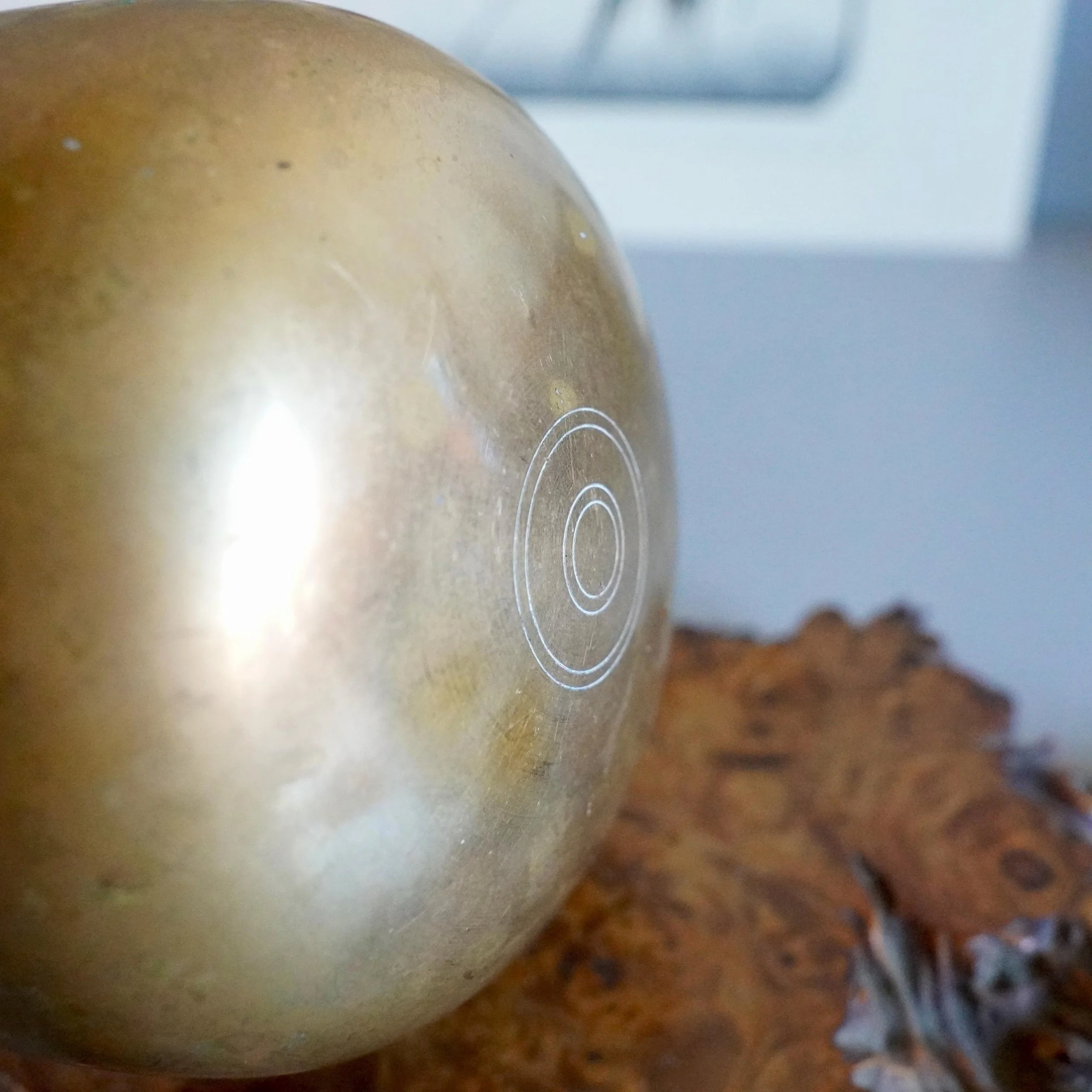 close-up of engraved ring mark on bronze orin bowl exterior