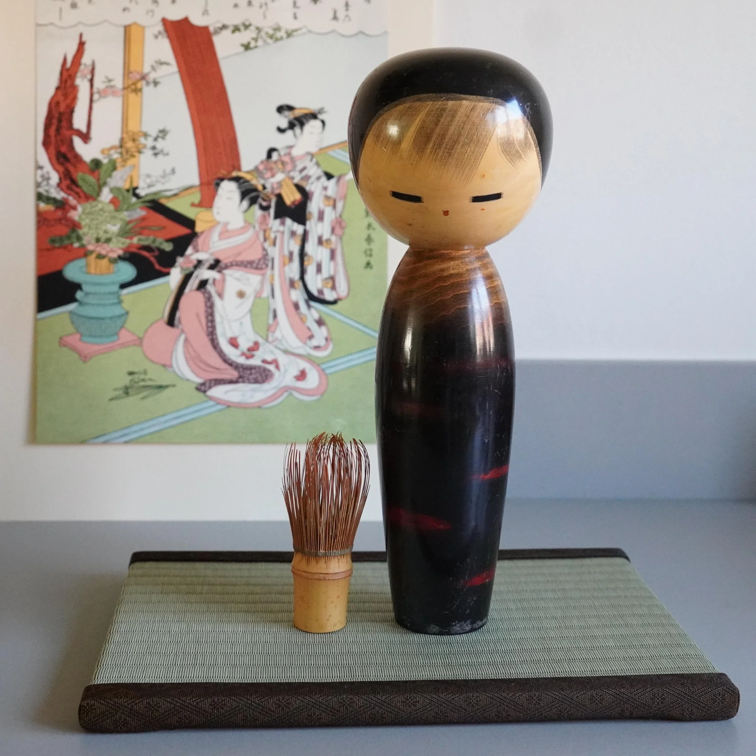 Sosaku kokeshi Chigozakura by Watanabe Masao, full front view styled with a chasen tea whisk on tatami
