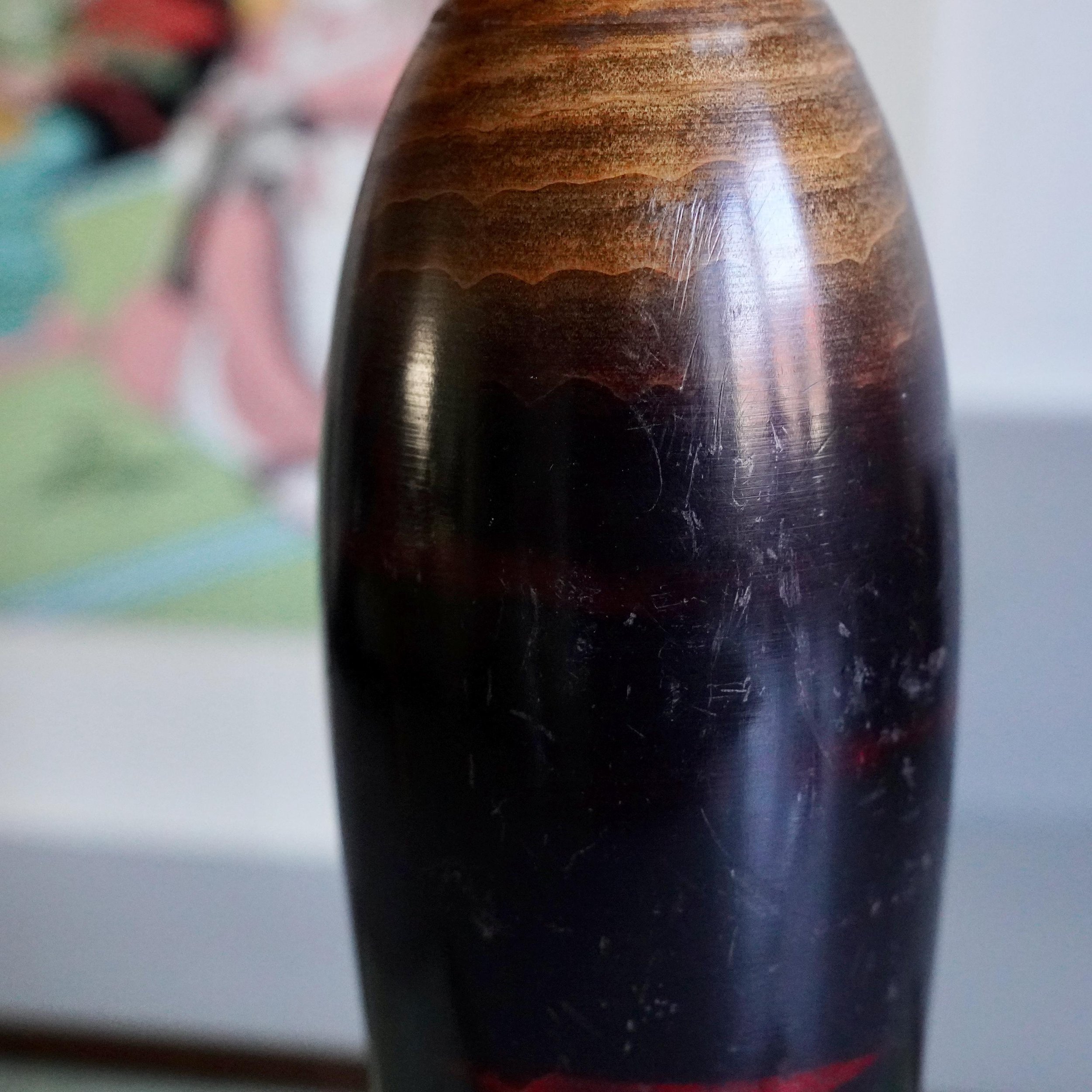 Detail of dark lacquered wood grain on Watanabe Masao sosaku kokeshi