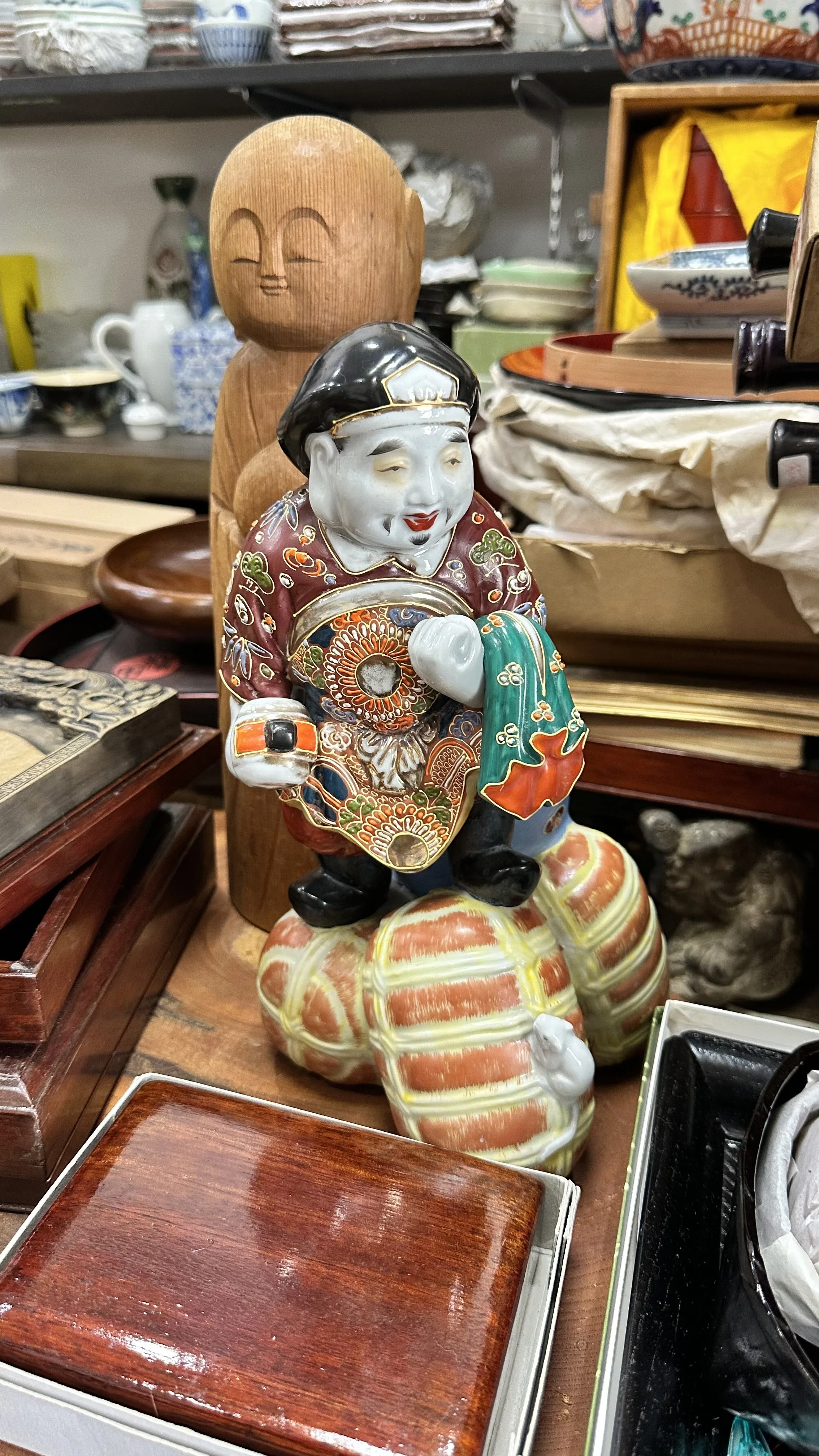Ceramic statue of Japanese fortune deity Ebisu at antique market