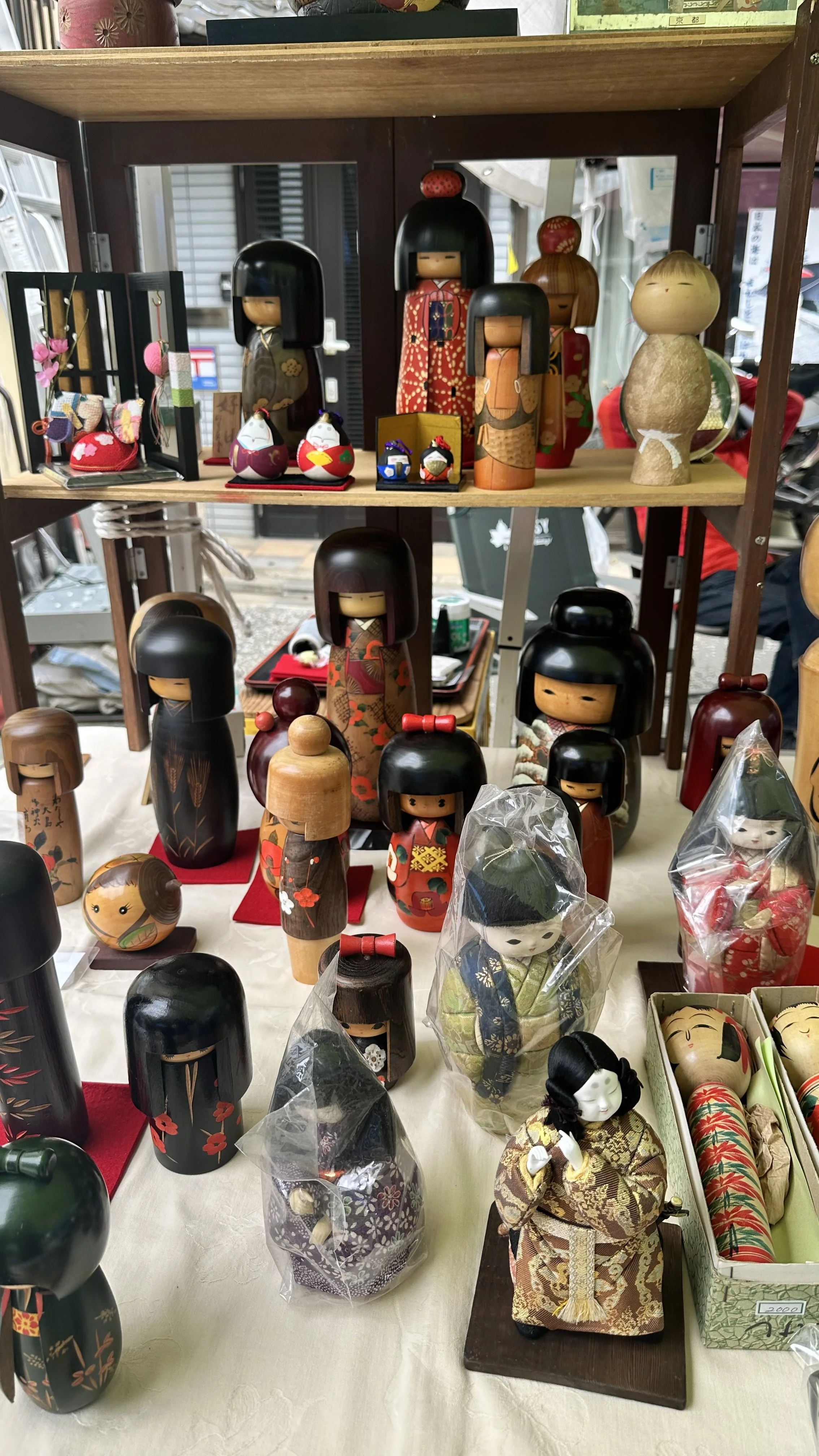 Collection of traditional wooden vintage kokeshi dolls at antique market