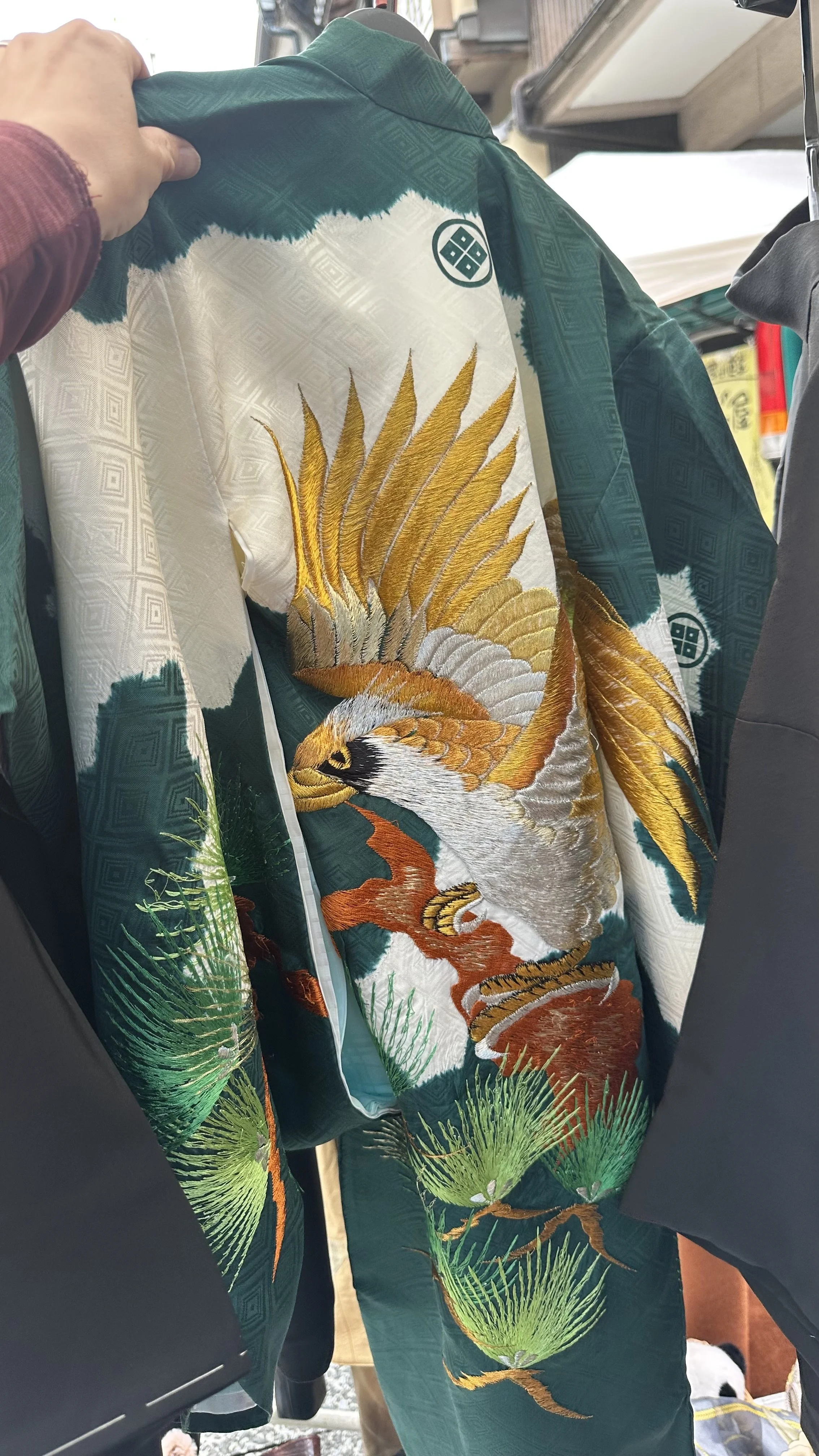 Back detail of a vintage Japanese haori with golden crane on green silk