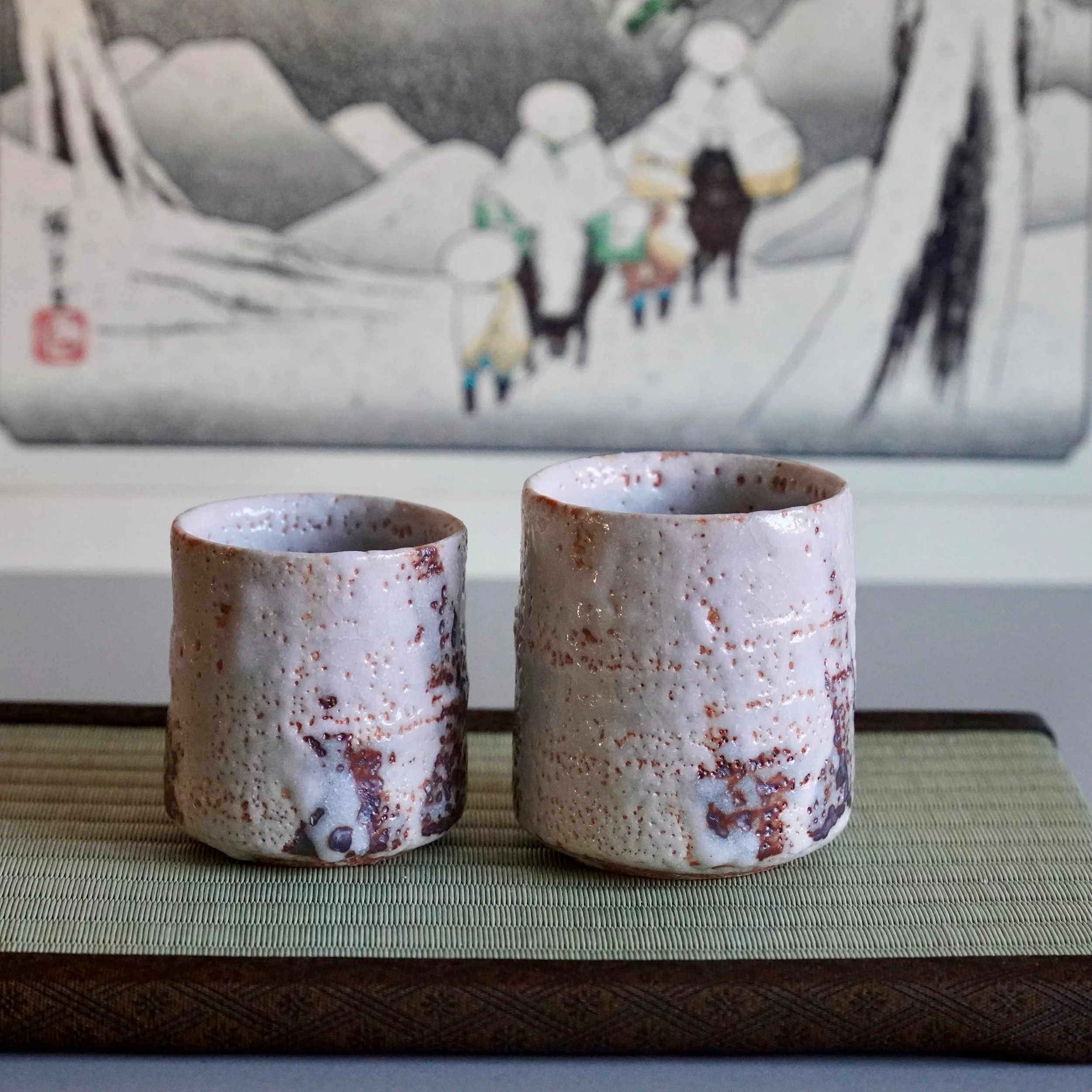 Katō Shōhei (Yōkun) Shino yunomi pair with textured white and reddish-brown speckled glaze.