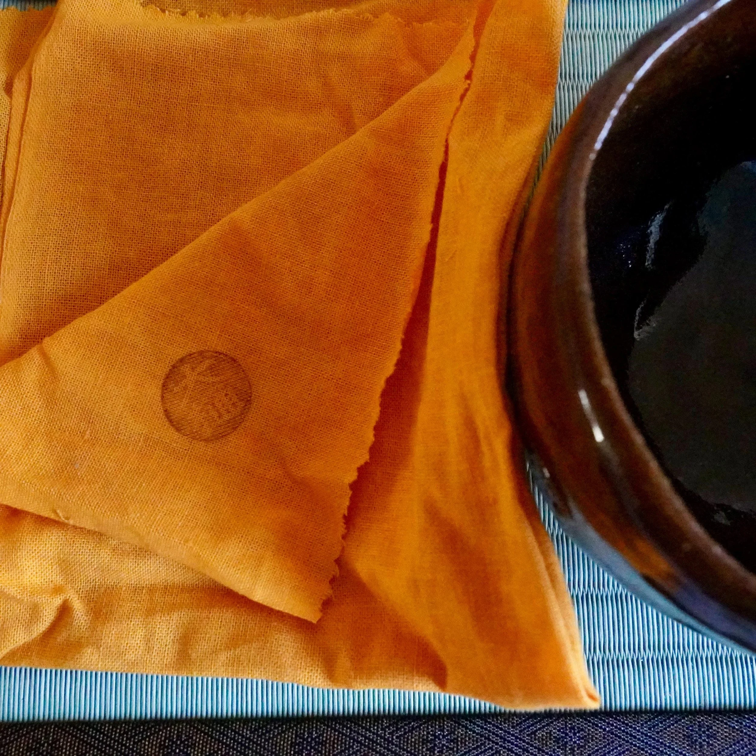 Ōbi-yaki chawan by Nakamura Chōami, wrapped in orange nishiki cloth with stamp