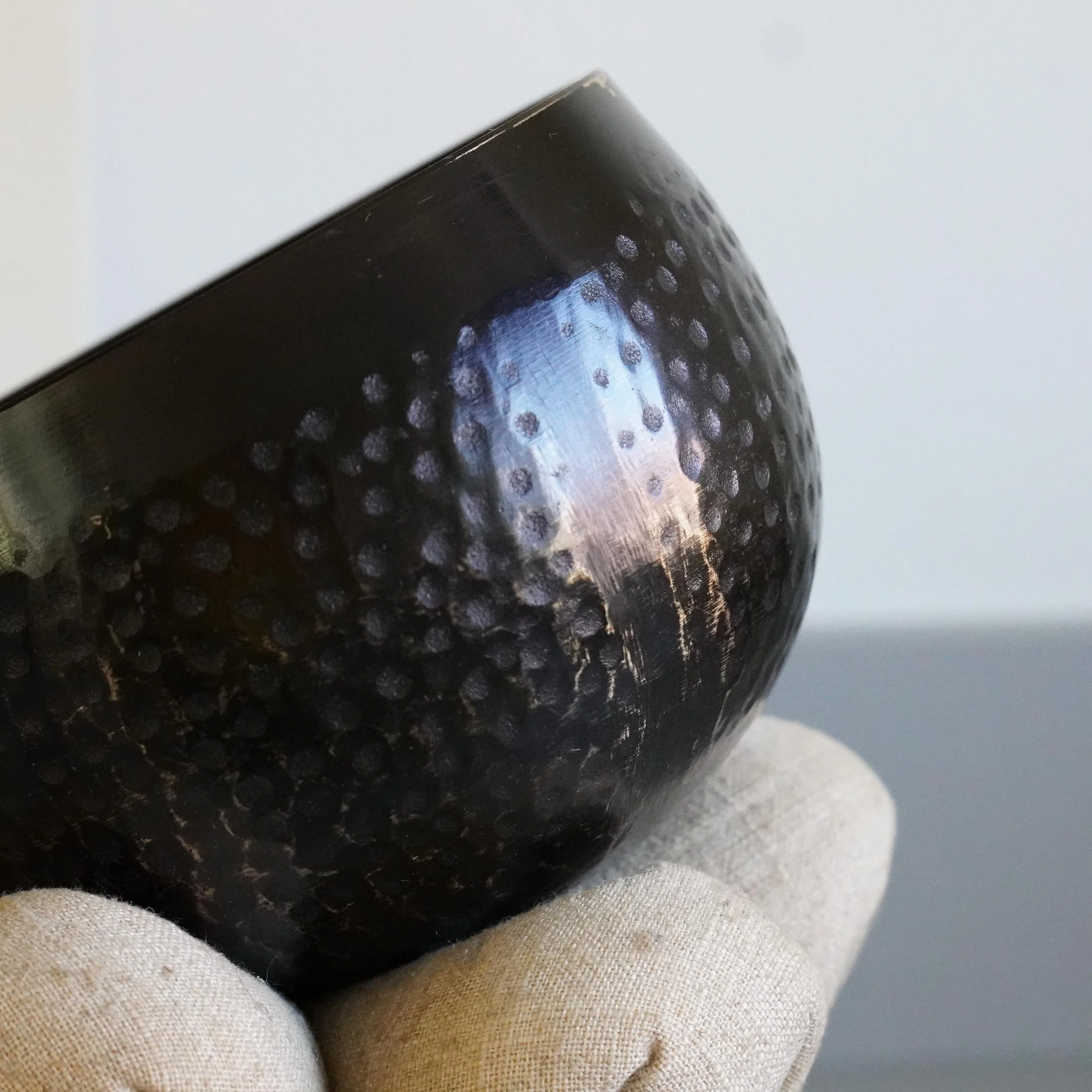 Close up of aged patina and hammer marks on orin bell rim