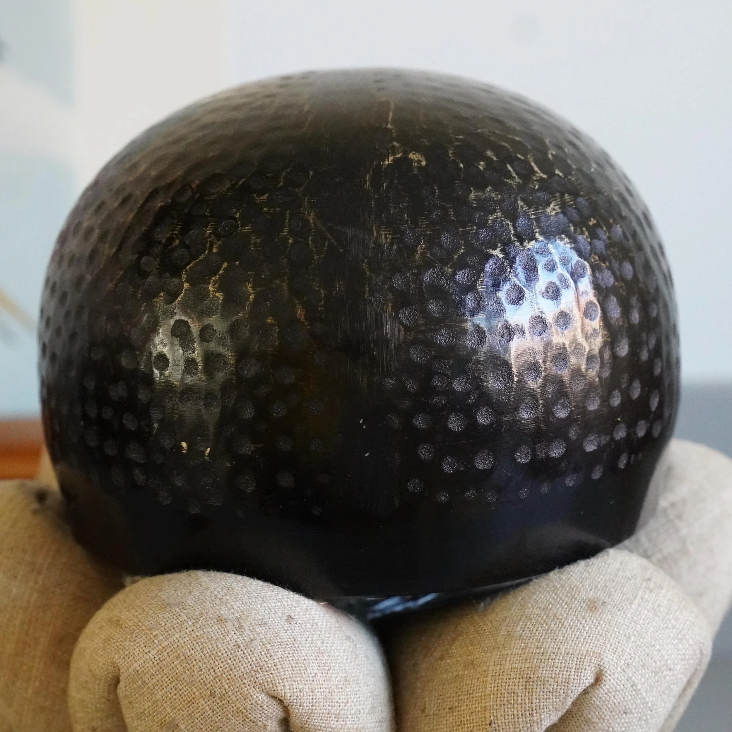 Full round view of bronze orin bowl on lotus petal cushion