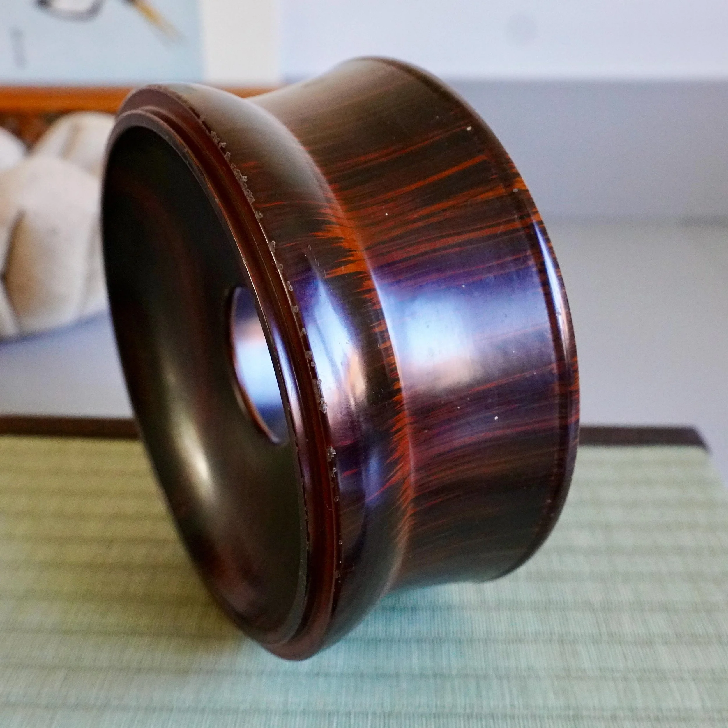 Lacquered wood stand side view showing red interior rim