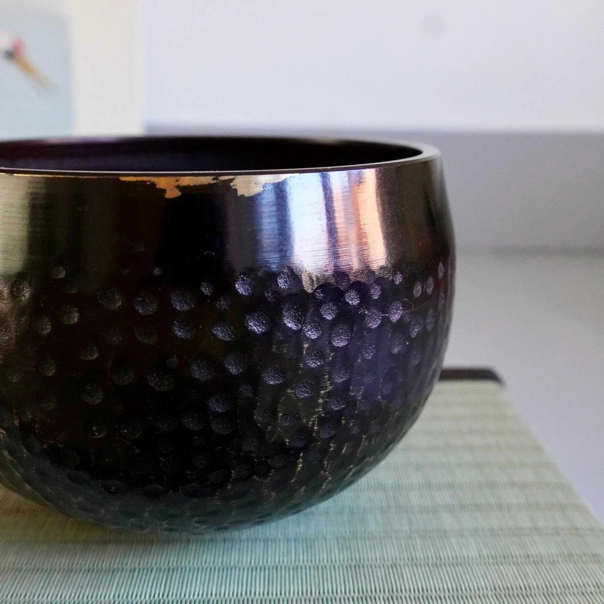 Interior of bronze orin bowl showing wear from temple use