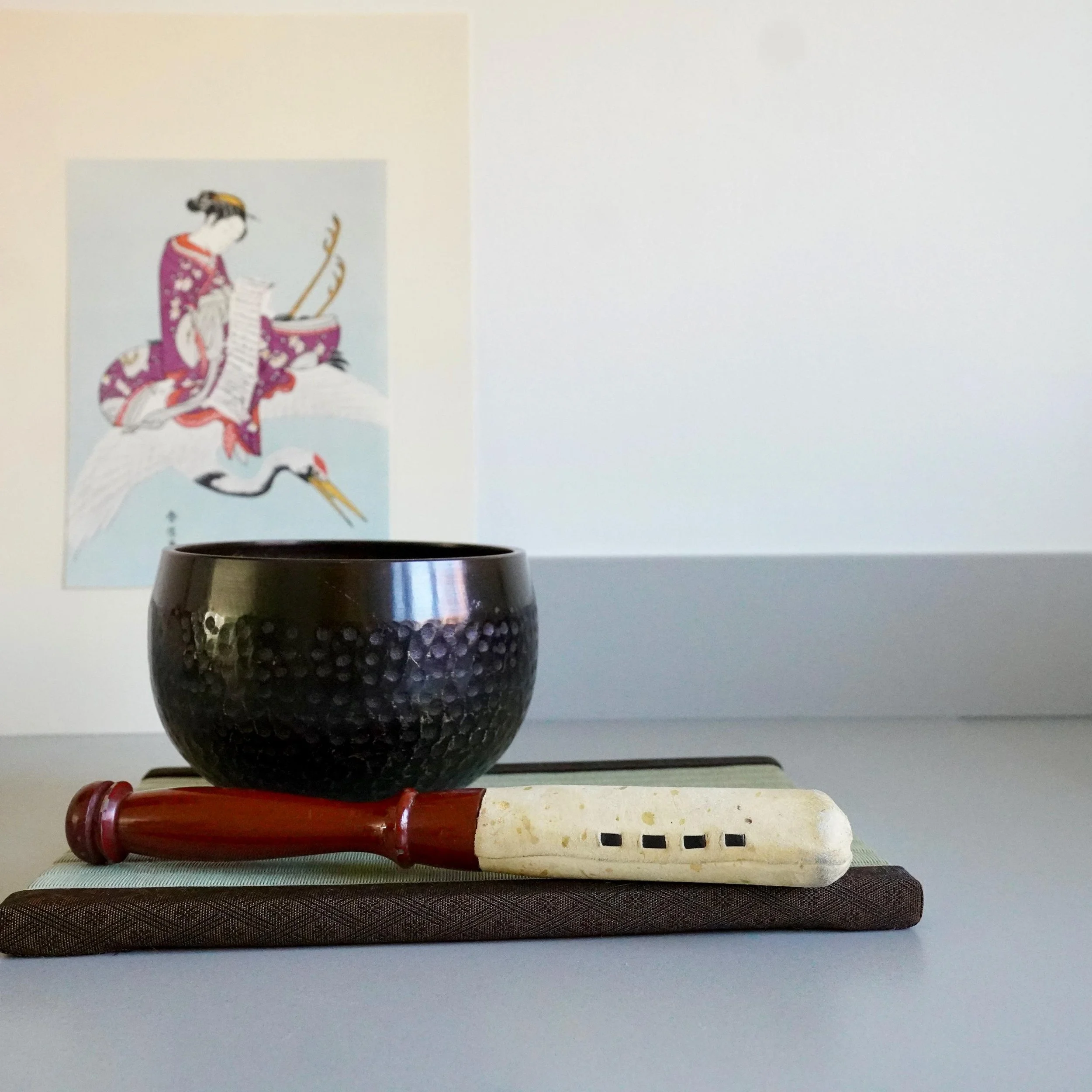 Orin bell, cushion and stand styled with ukiyo-e scroll backdrop