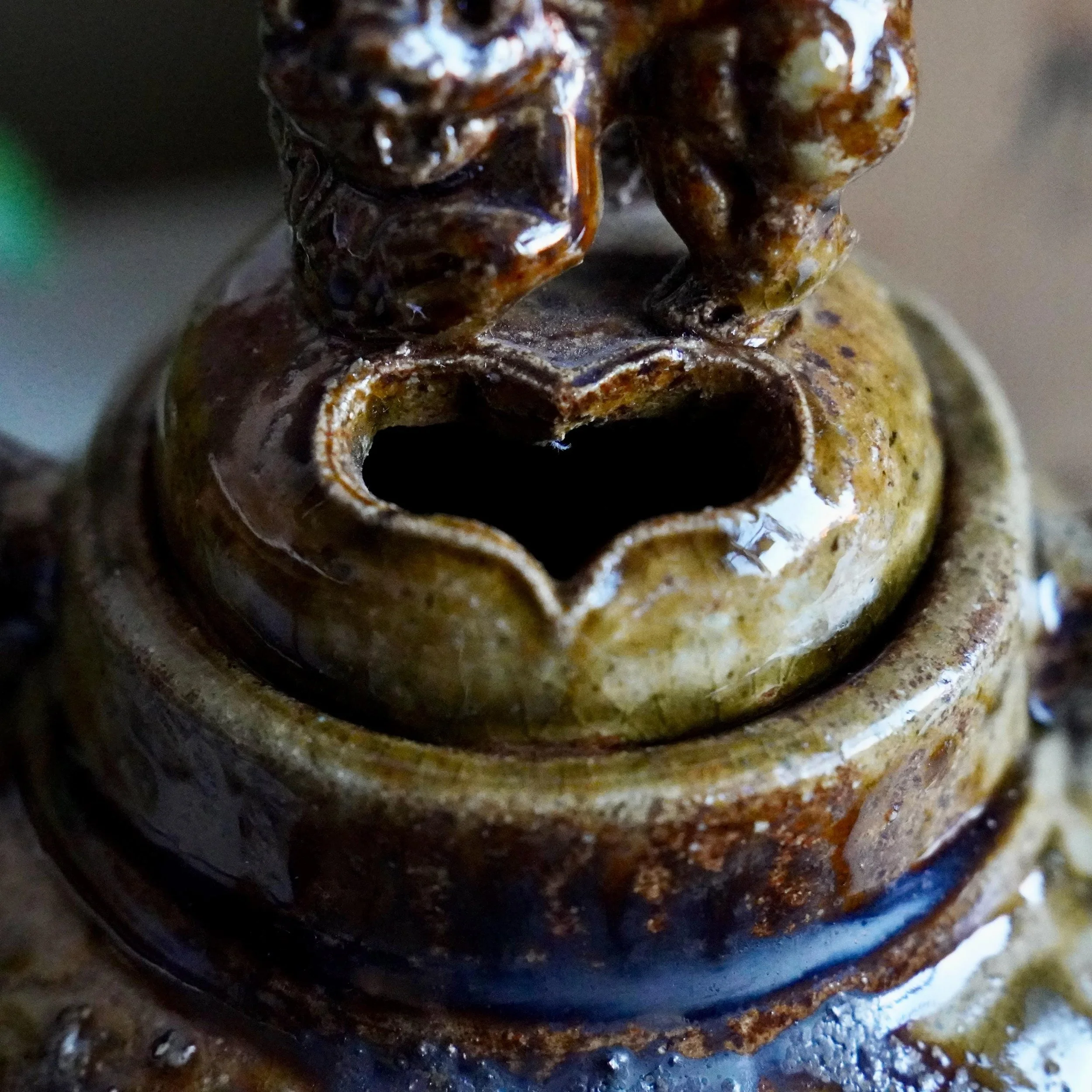 Heart-shaped smoke opening beneath shishi lid, close up