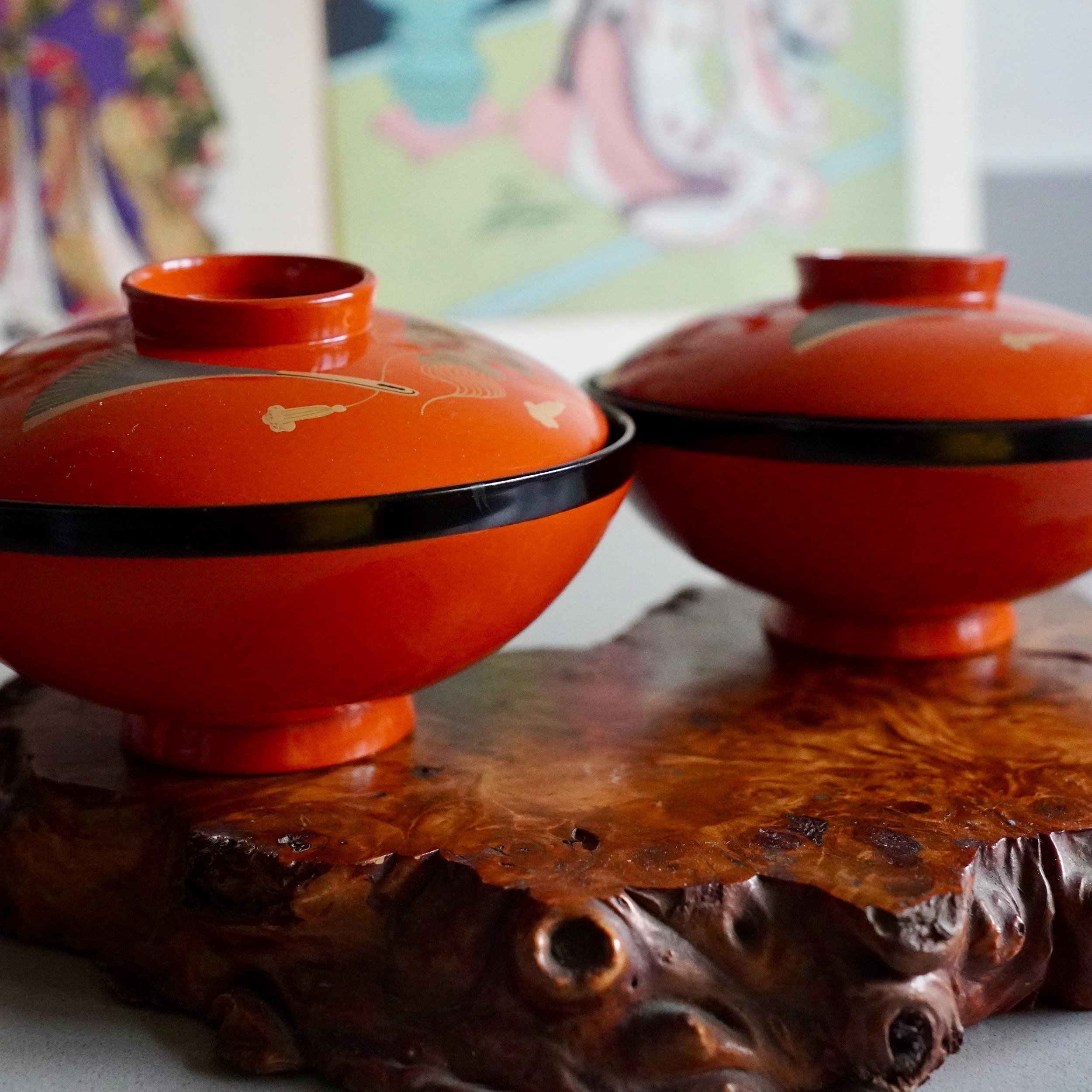 Pair of open urushi lacquer owan bowls with lids on burl wood stand