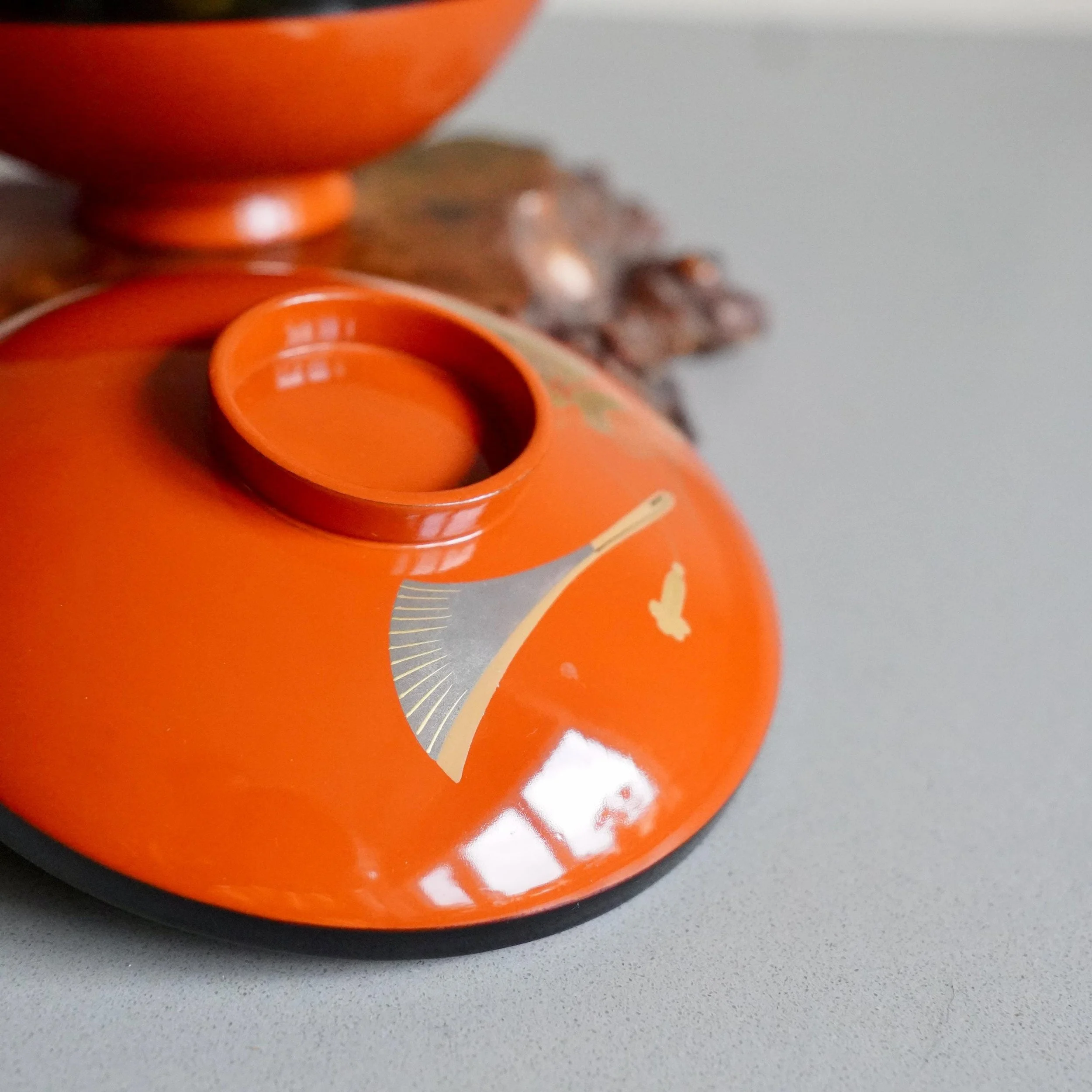 Urushi lacquer owan lid tilted to show gold maki-e Okina mask detail