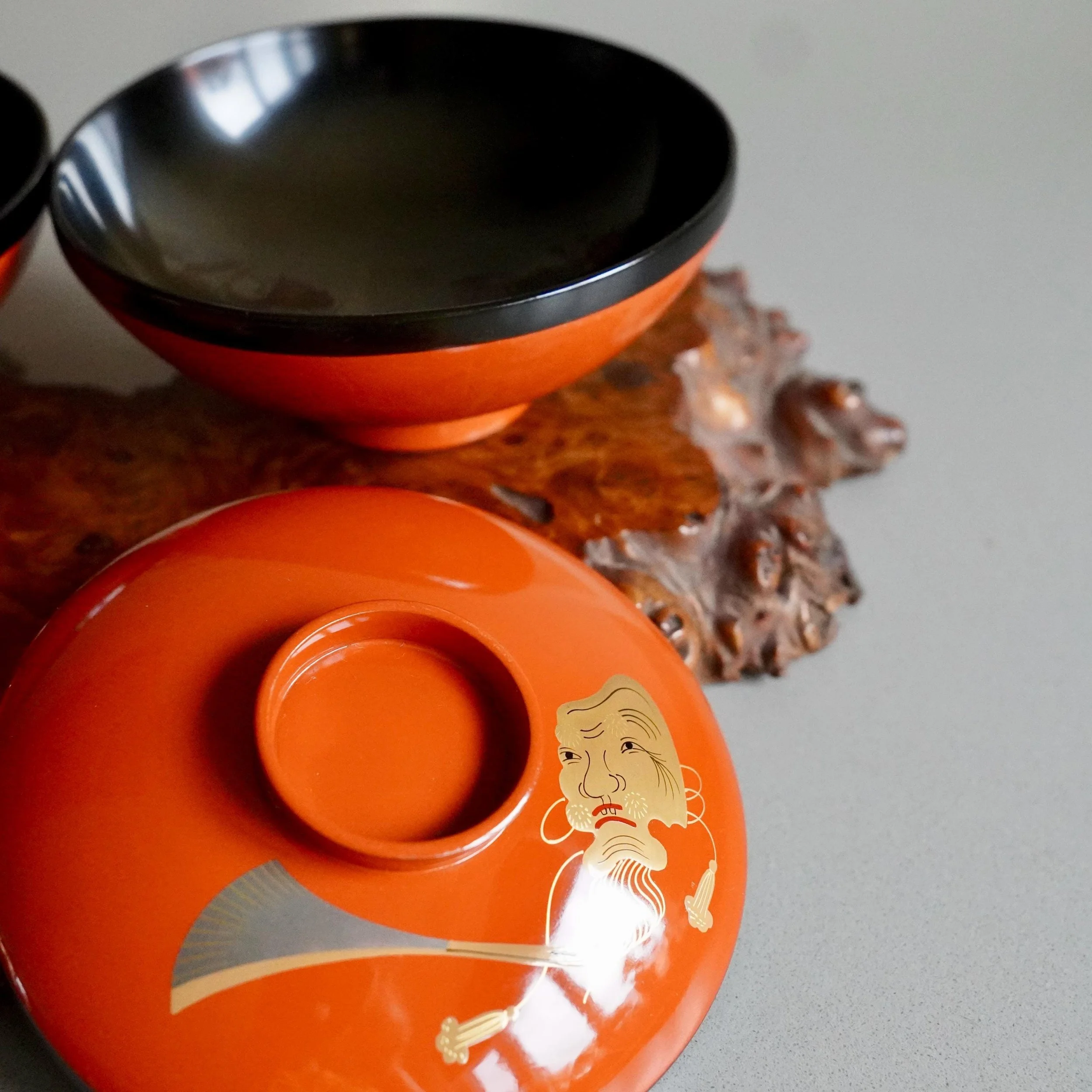 vermillion urushi owan bowl beside lid showing black lacquer interior