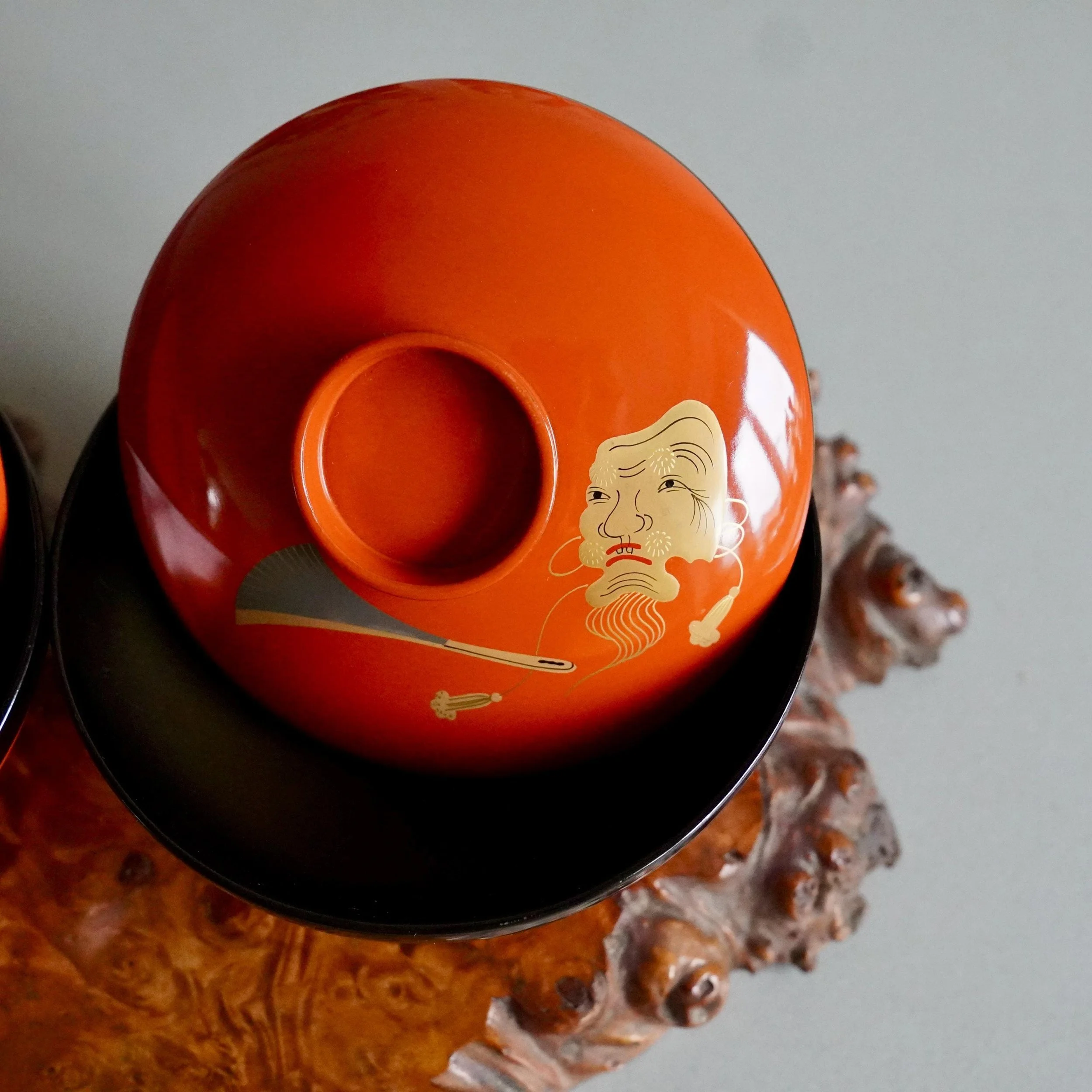 Gold maki-e Okina mask detail on vermillion urushi lacquer owan lid