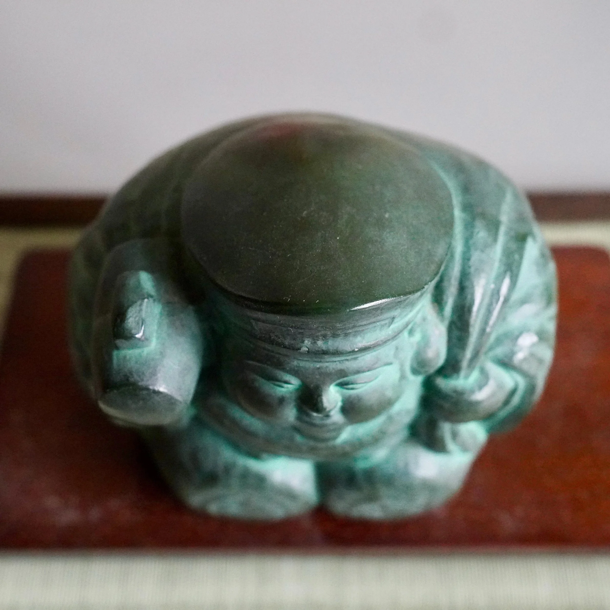 top profile Japanese bronze Daikokuten showing characteristic flat black cap detail, green aged patina, okimono signed Shuho 秀峰作 late Showa period Japan