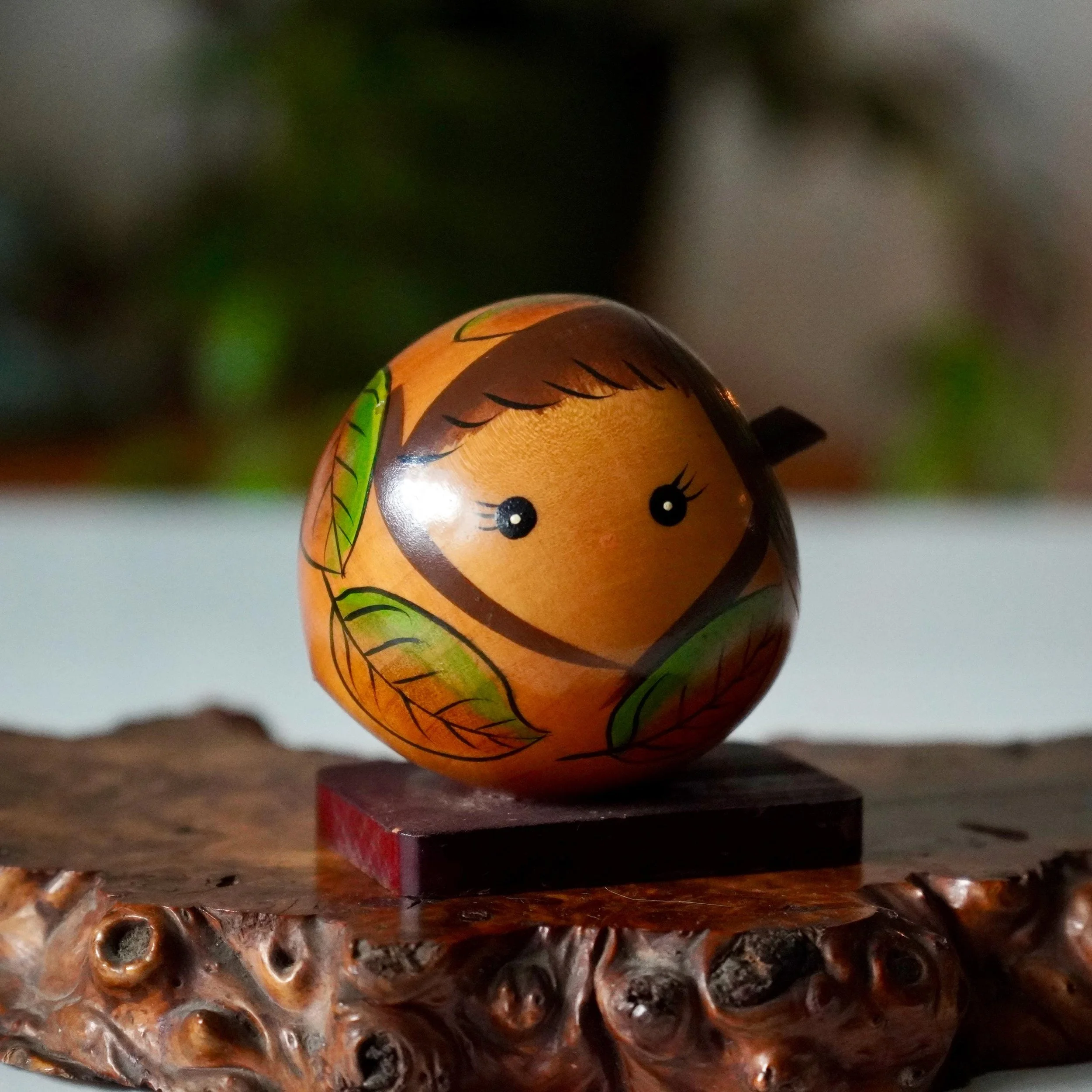 Sōsaku kokeshi on wooden plank by Tamura Chie donguri acorn girl form with autumn leaf body decoration, signed, Shōwa period Japan