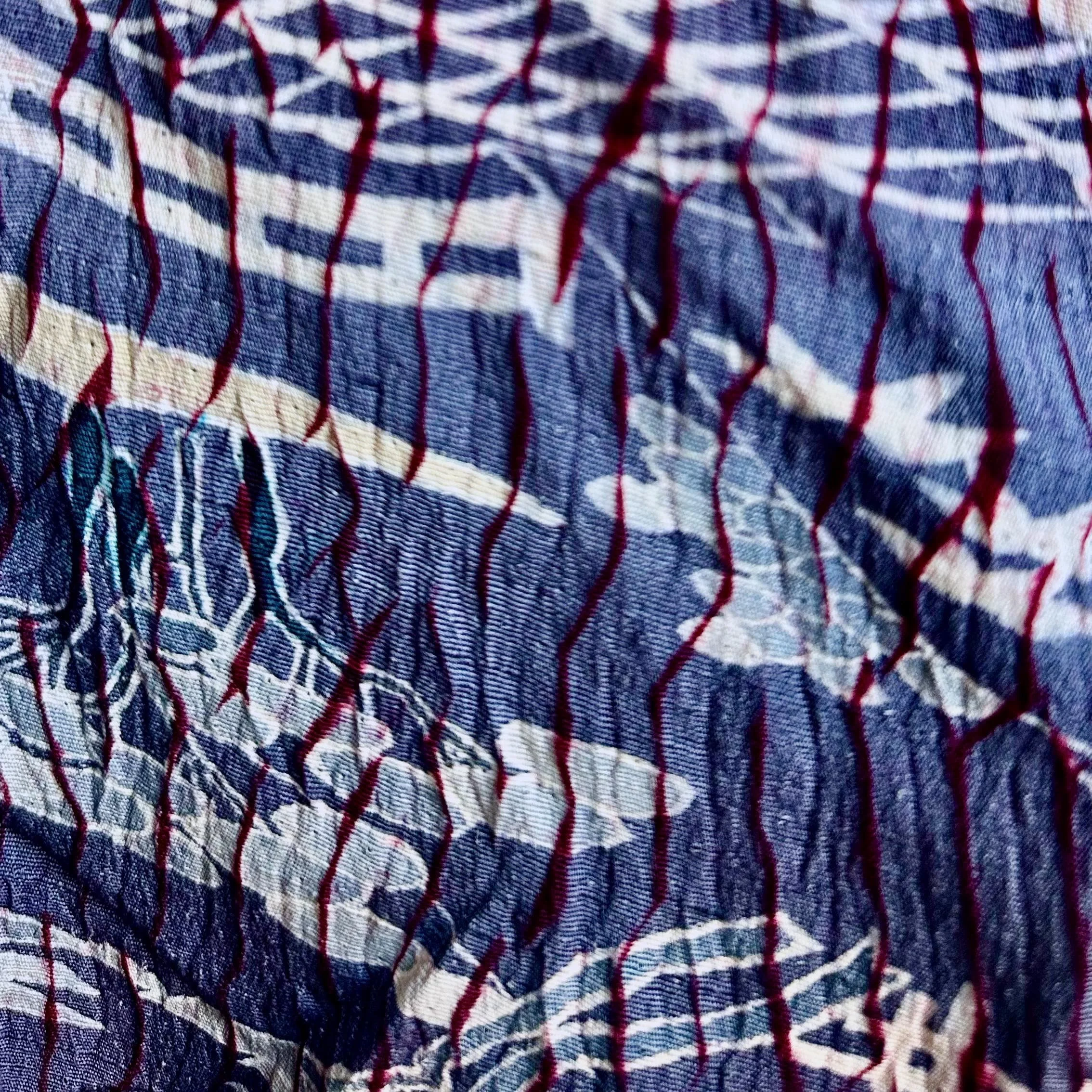 Close-up chirimen silk crepe weave texture, crinkled surface with woven burgundy lines, vintage Japanese haori