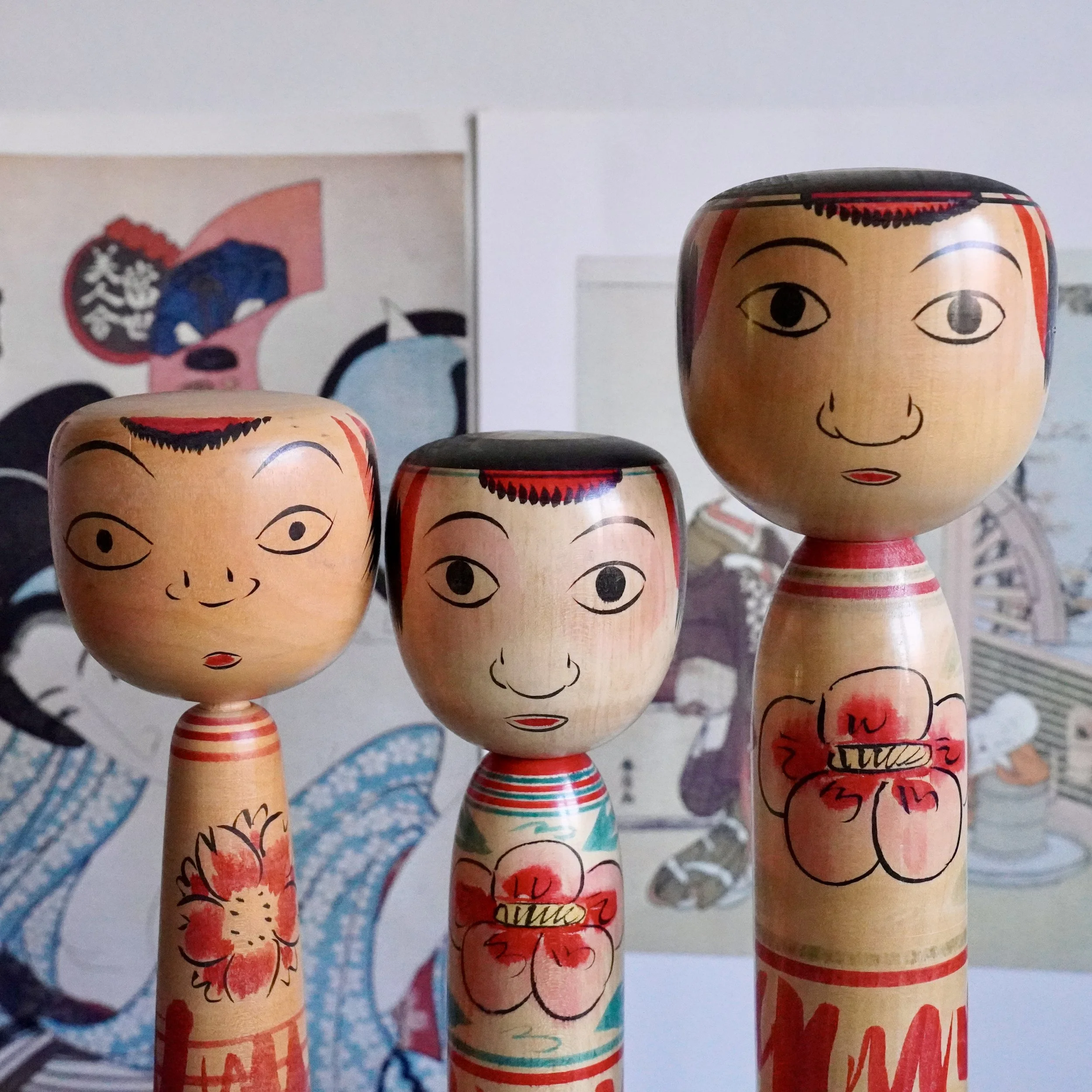Three Nakanosawa Takobozu kokeshi displayed together, signed vintage Japanese wooden dolls from two makers within the same Tsuchiyu lineage, Saito Tokuju and Seya Juji