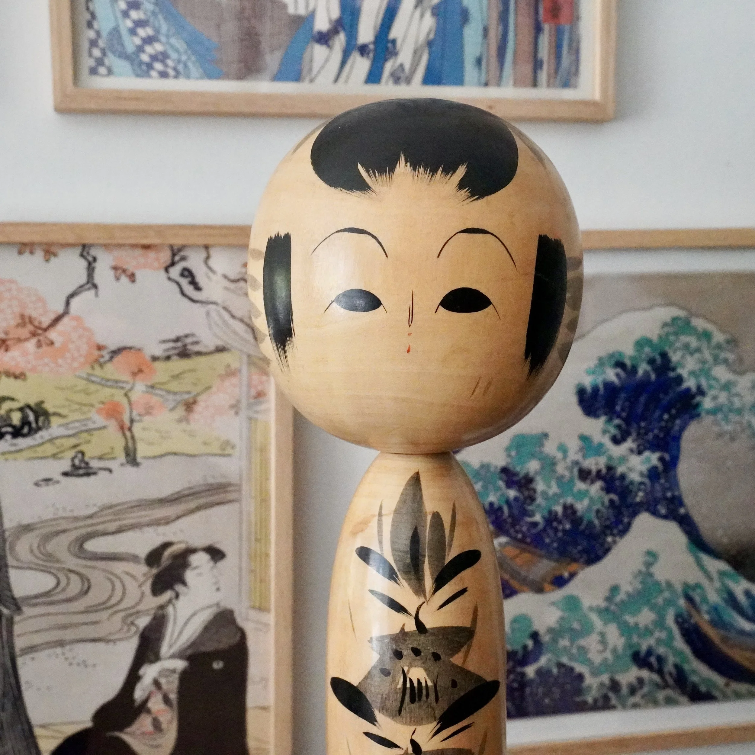 Japanese kokeshi doll painted face, narrow eyes and soft eyebrows, Showa period folk art, tetsuen signed