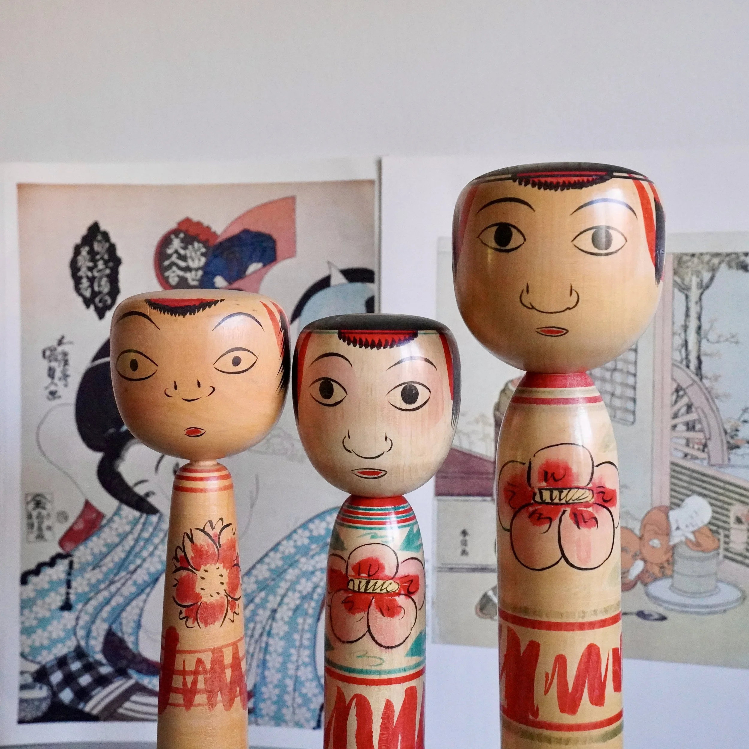 Three Nakanosawa Takobozu kokeshi displayed together, signed vintage Japanese wooden dolls from the Tsuchiyu lineage