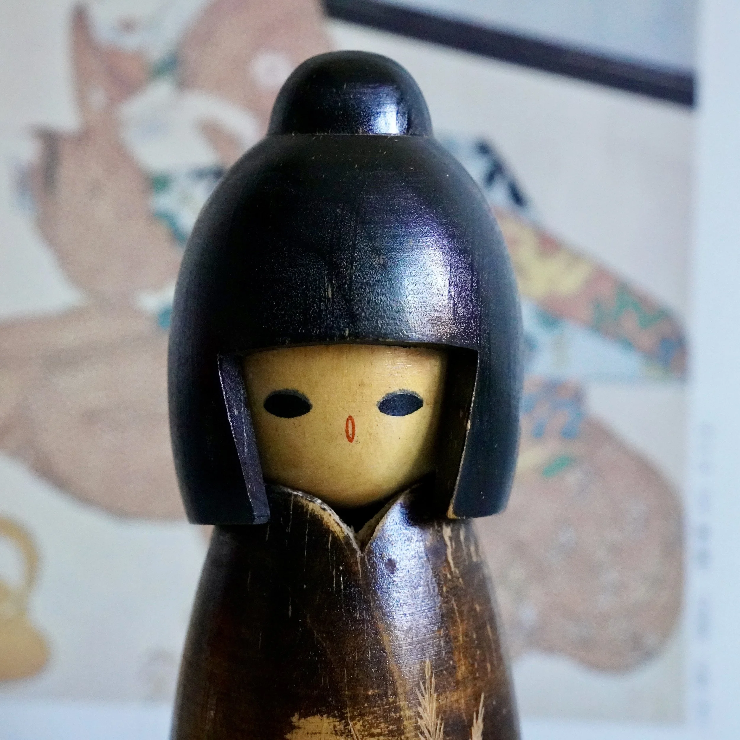 Close view of carved kokeshi face and hairstyle, Takeda Masashi