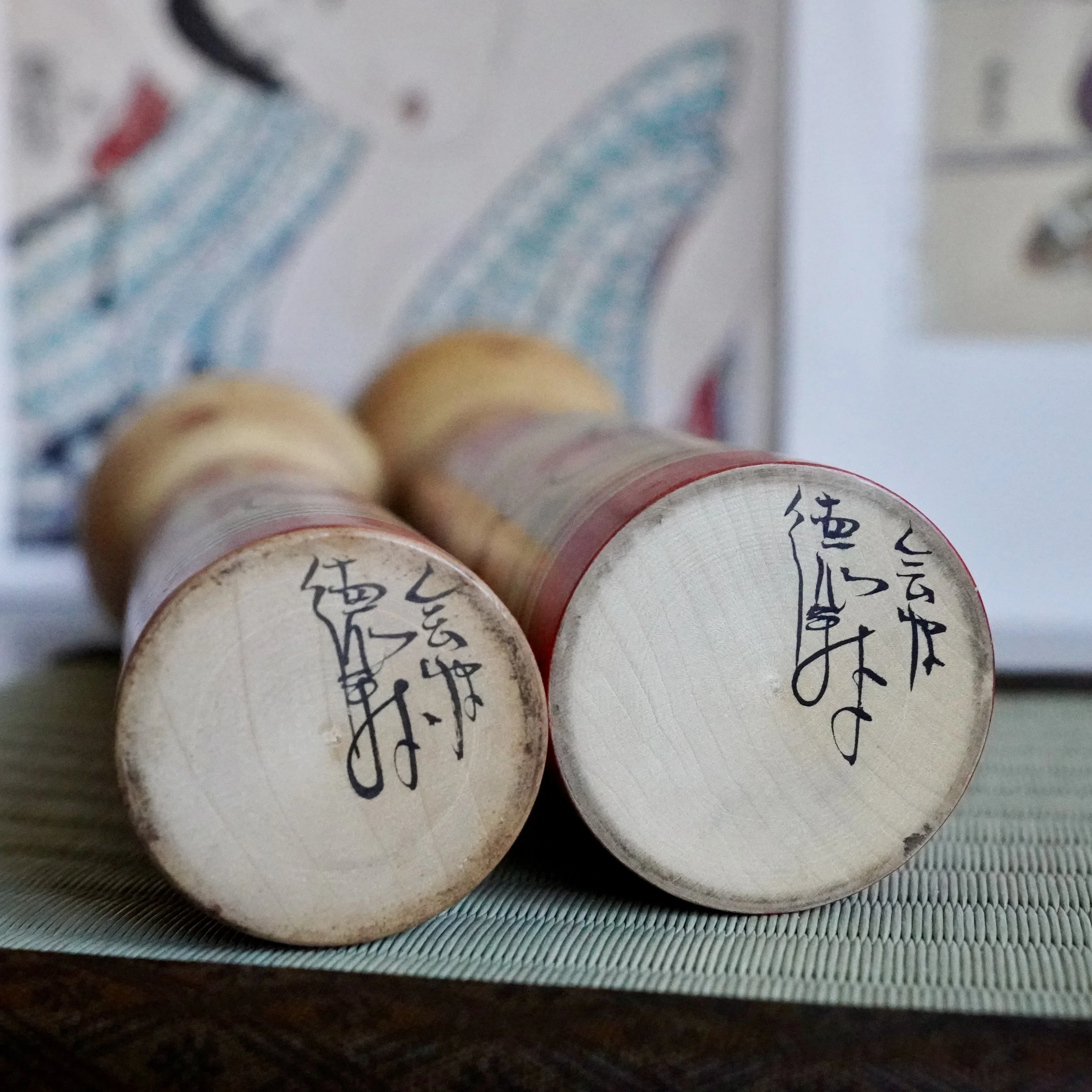 Signed bases of Nakanosawa Takobozu kokeshi pair showing maker's kanji signature, Saito Tokuju vintage kokeshi