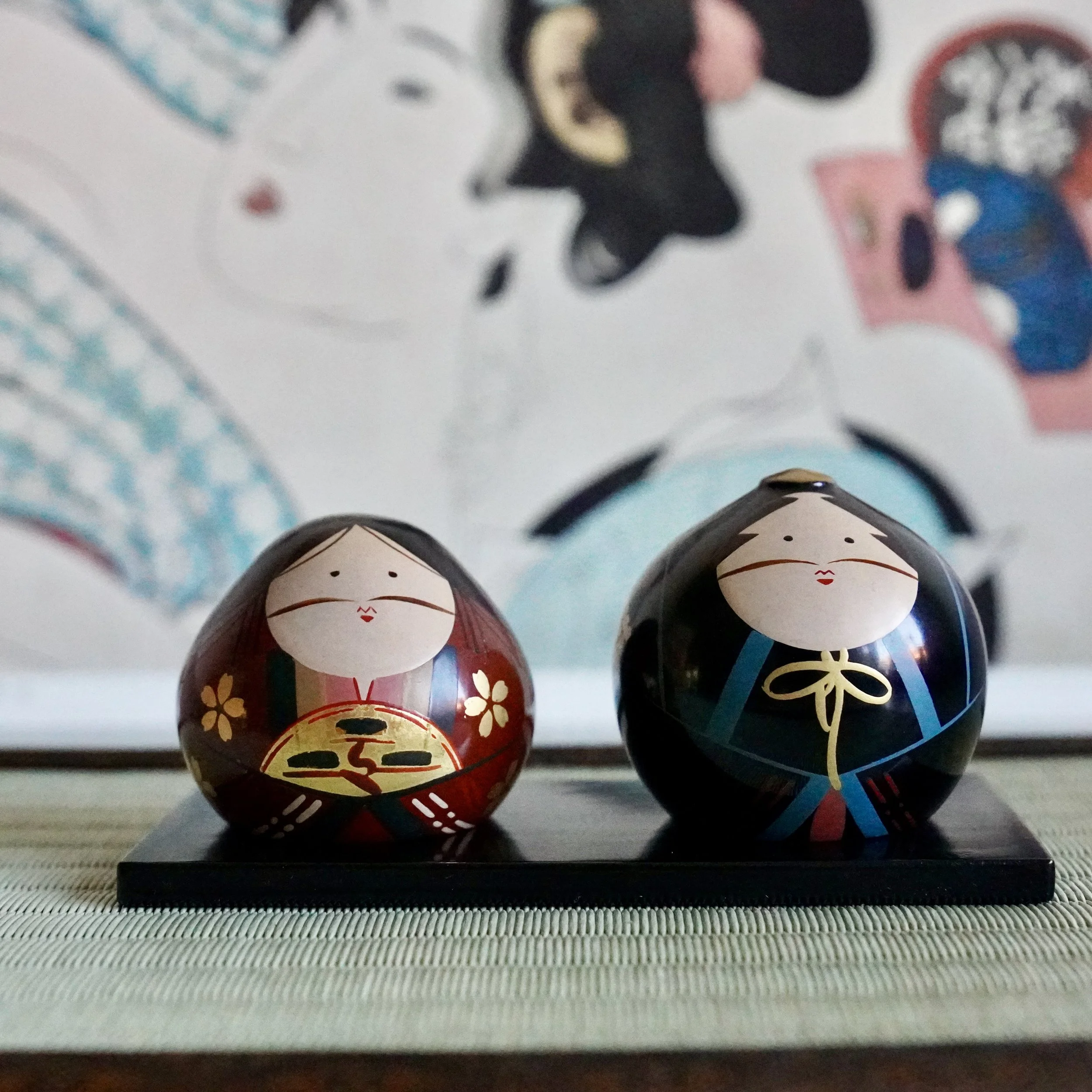 Ouchi-nuri hina doll pair on black lacquered stand, full figure front view